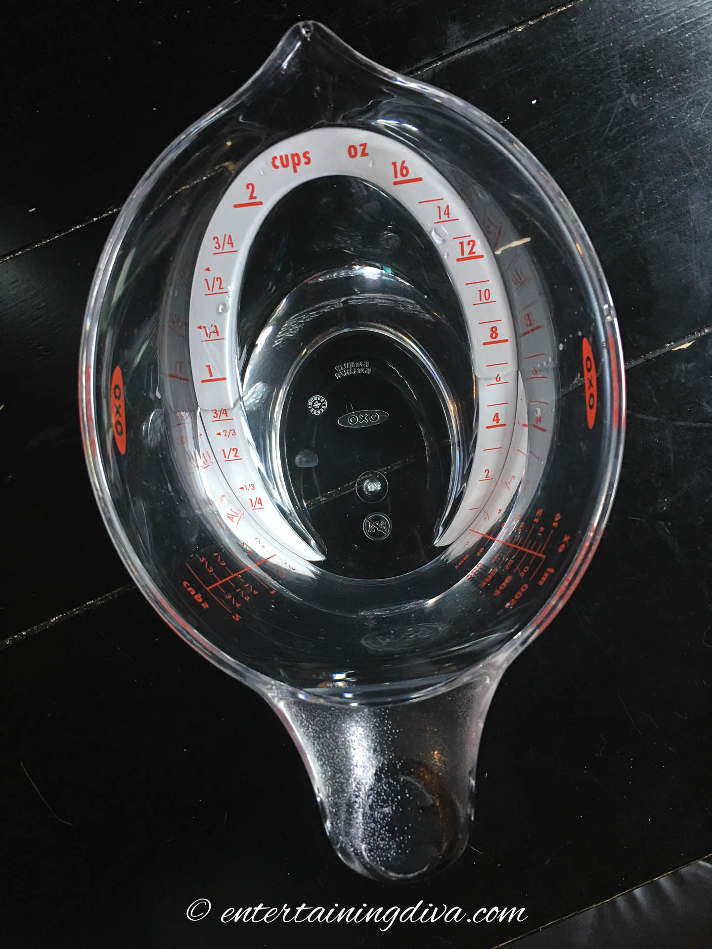 A measuring cup filled to a little less than 1 cup of liquid