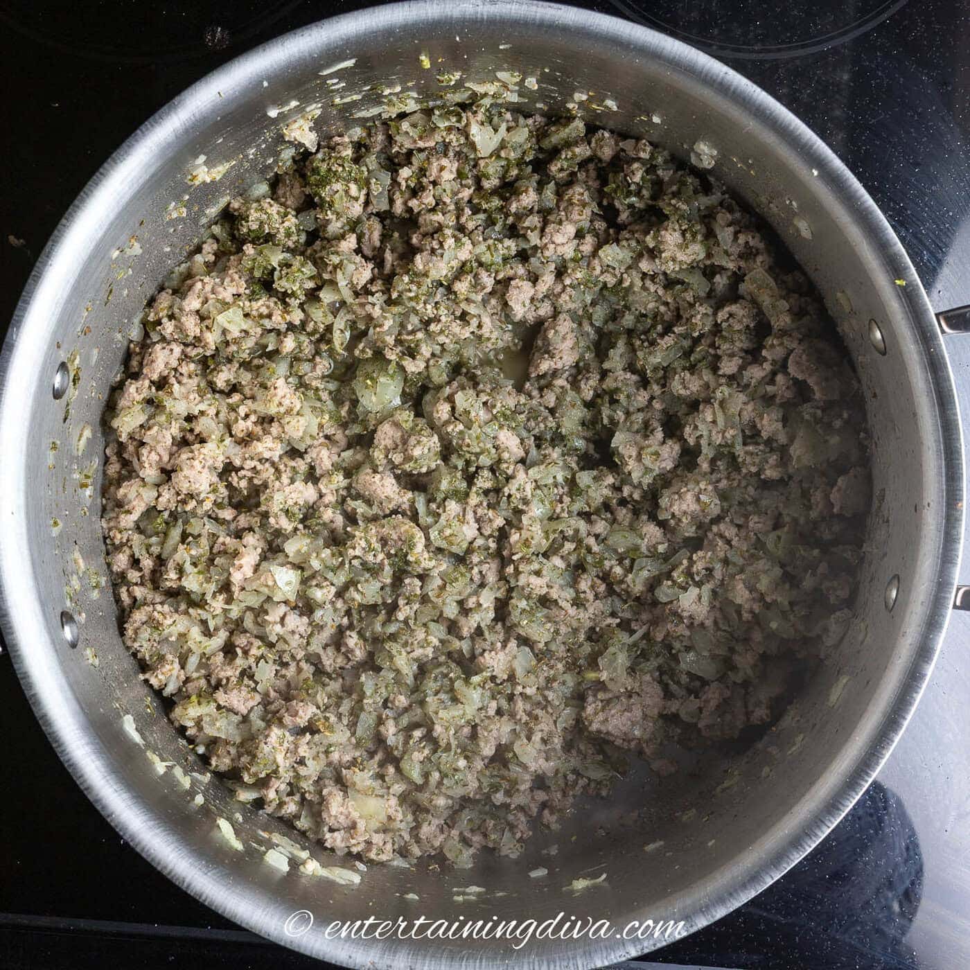 ground beef cooking with spices in a stock pot