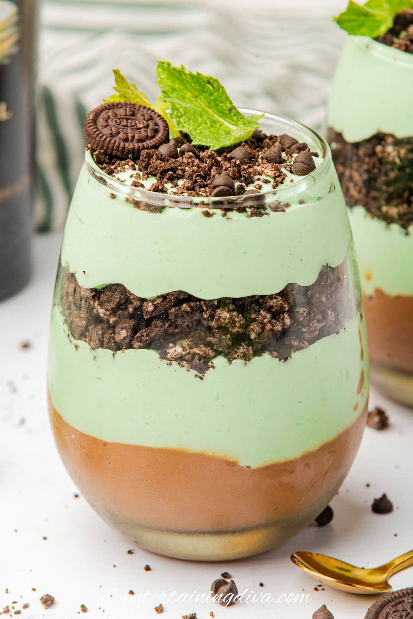 Side view of a St Patrick's Day parfait topped with Oreo cookies and mint leaves