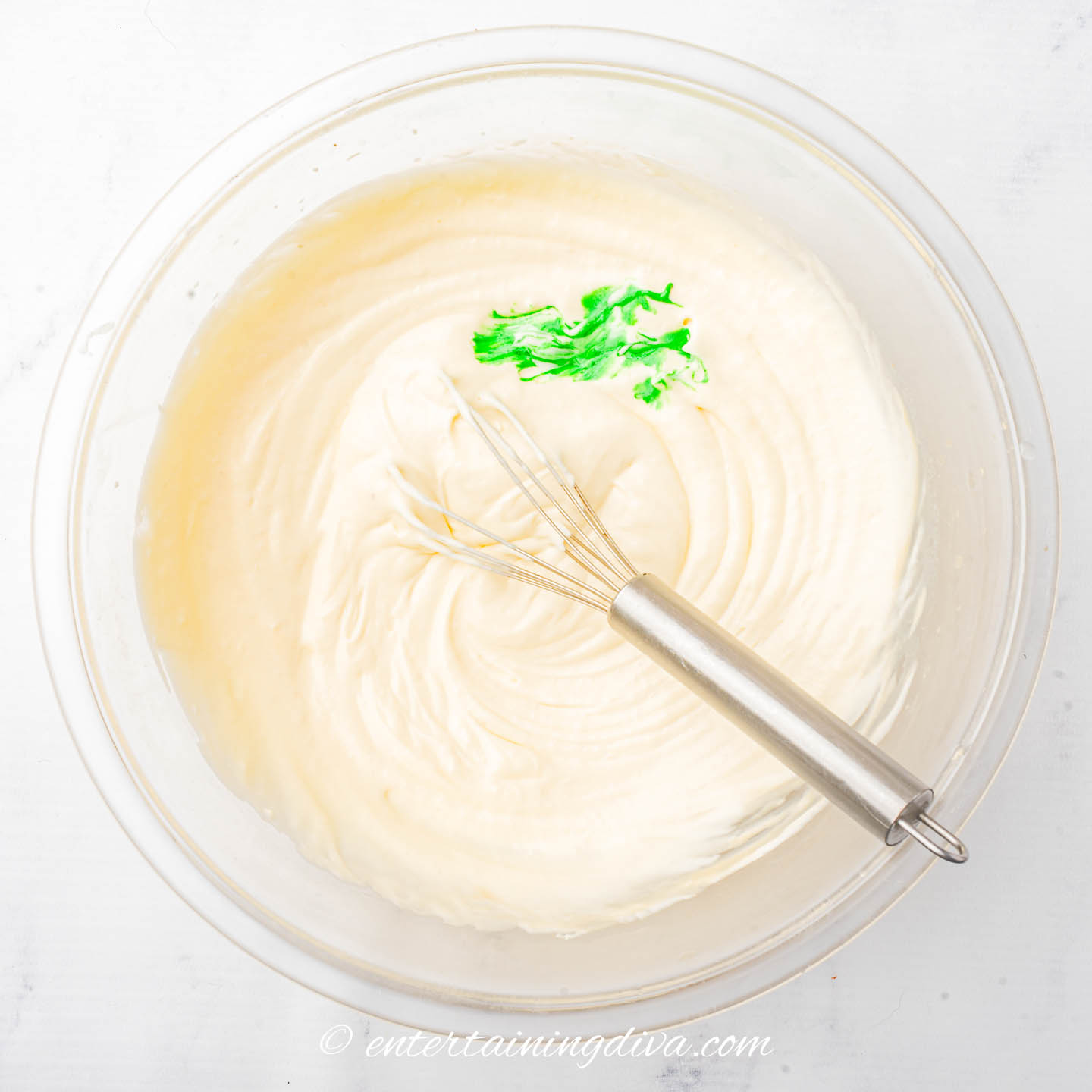Cool whip in a bowl with a few drops of green food color