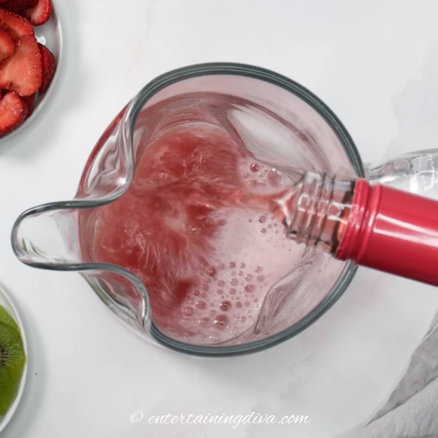 Rose wine being poured into a pitcher