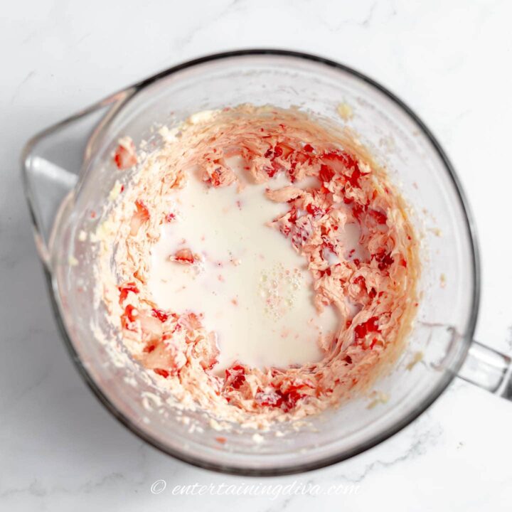 strawberries, butter and milk in a mixing bowl