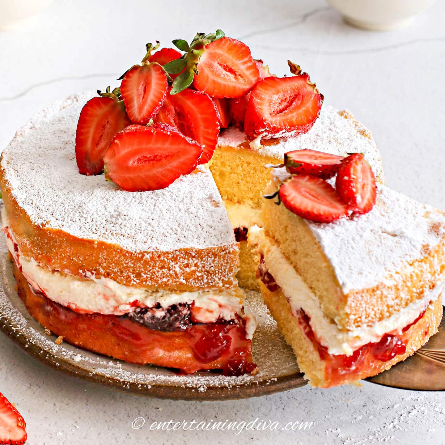 strawberry shortcake cake with a slice out of it