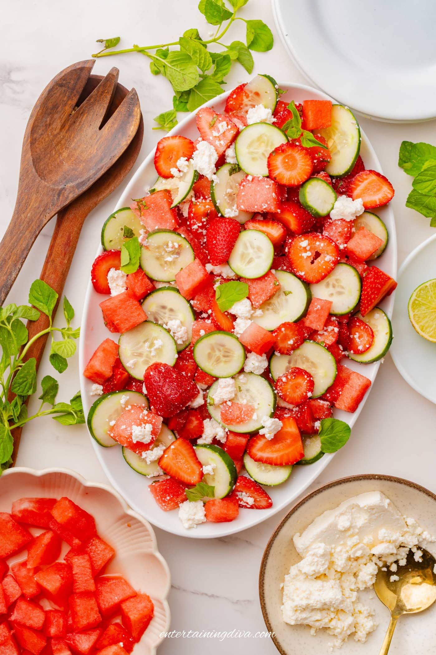 Overhead picture of strawberry watermelon cucumber salad on a serving plate.