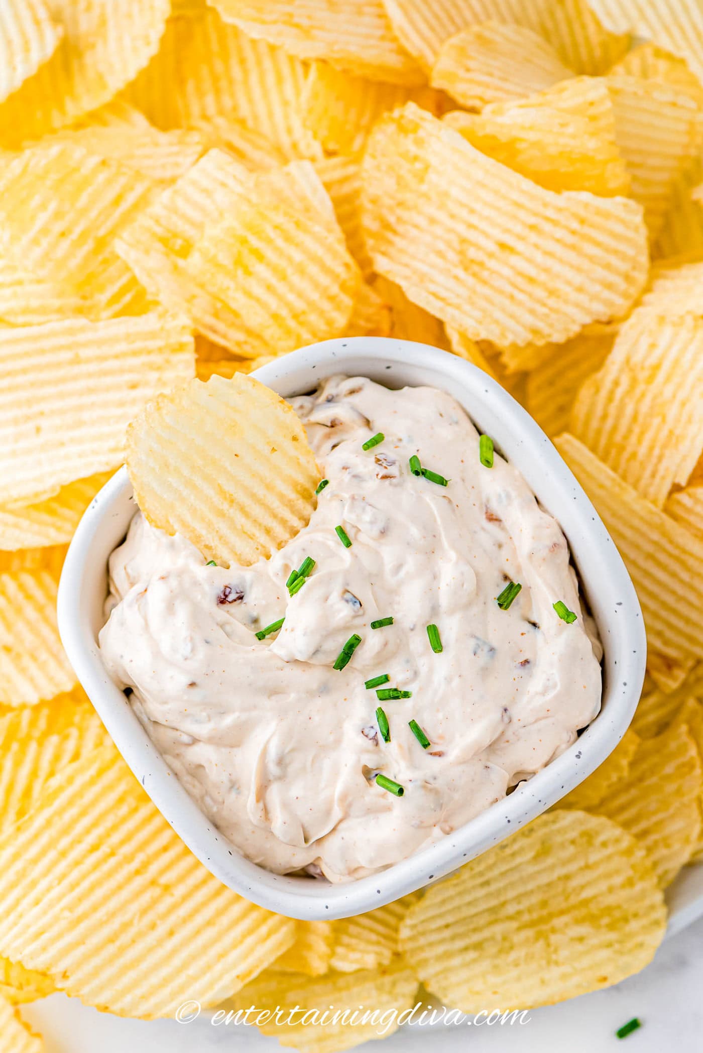 bowl of french onion dip with a chip dipped in it