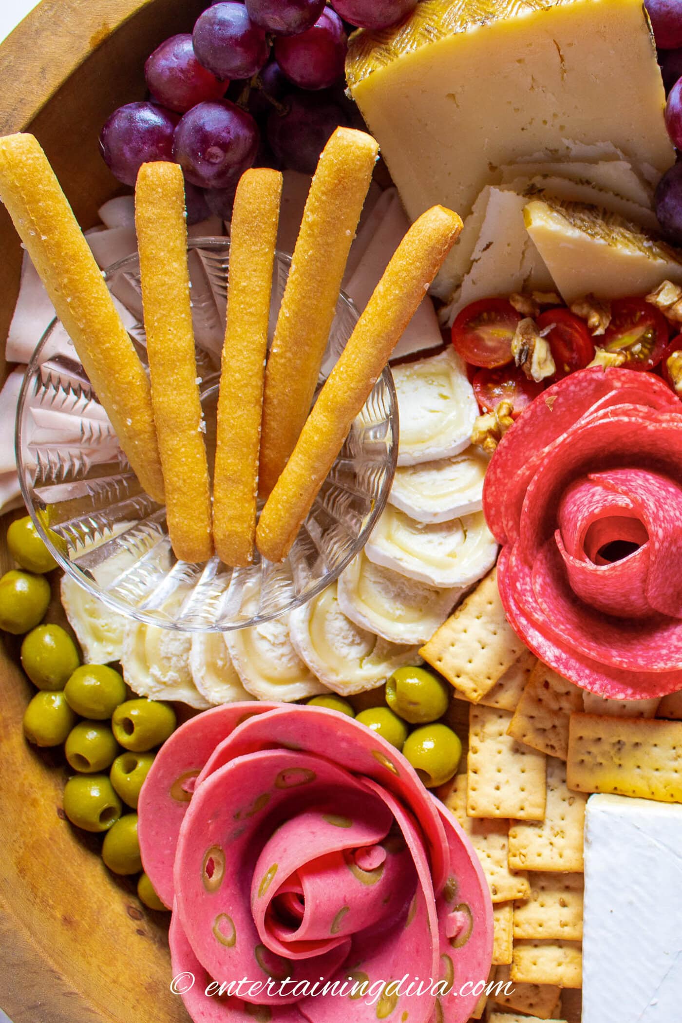 A plate of food with bread sticks and cheese.
