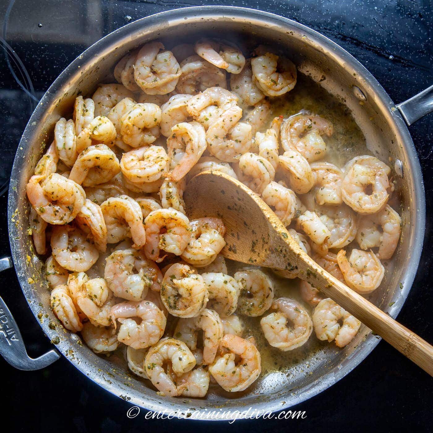 Thai red curry shrimp cooking in a frying pan