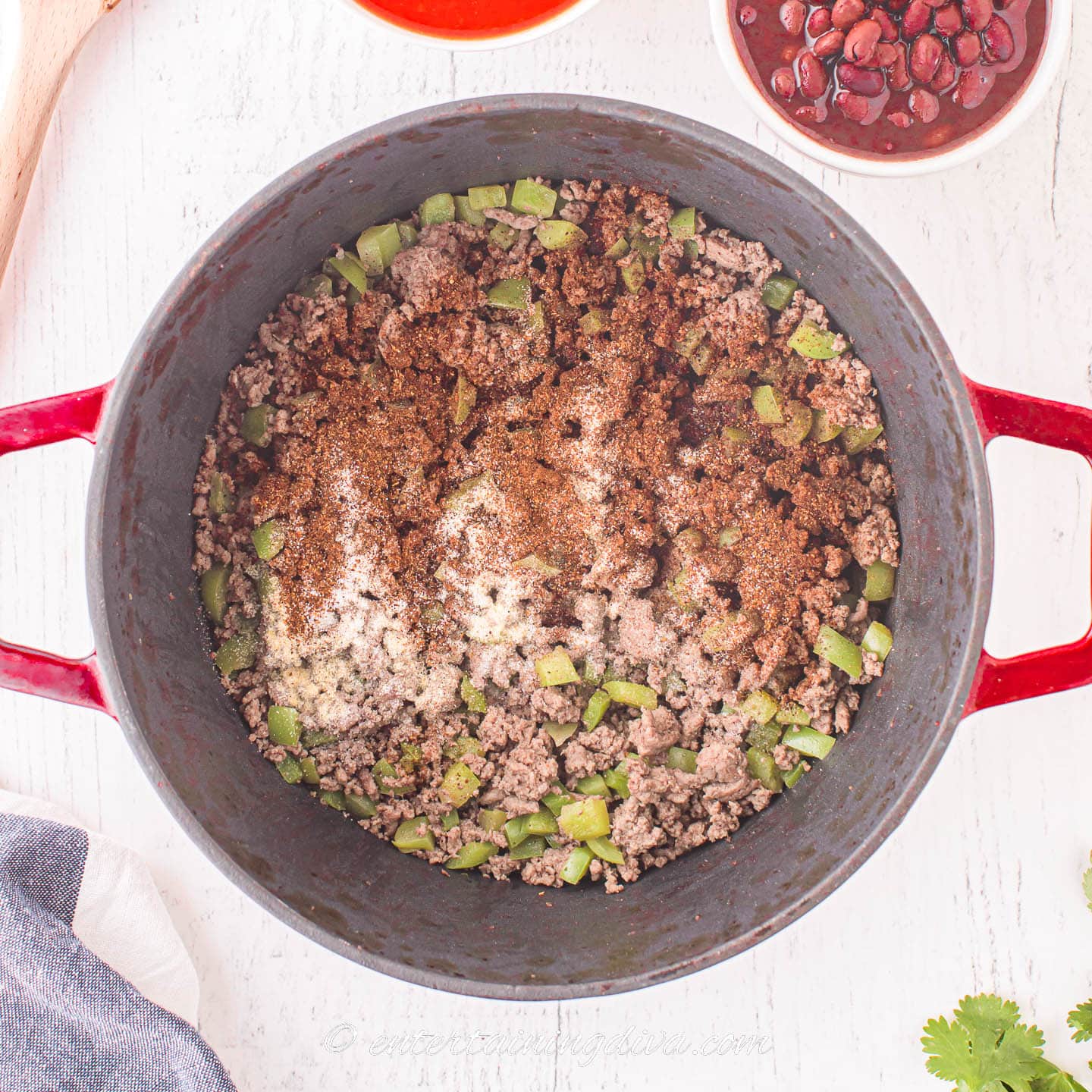Ground beef, bell peppers and chili spices in a dutch oven