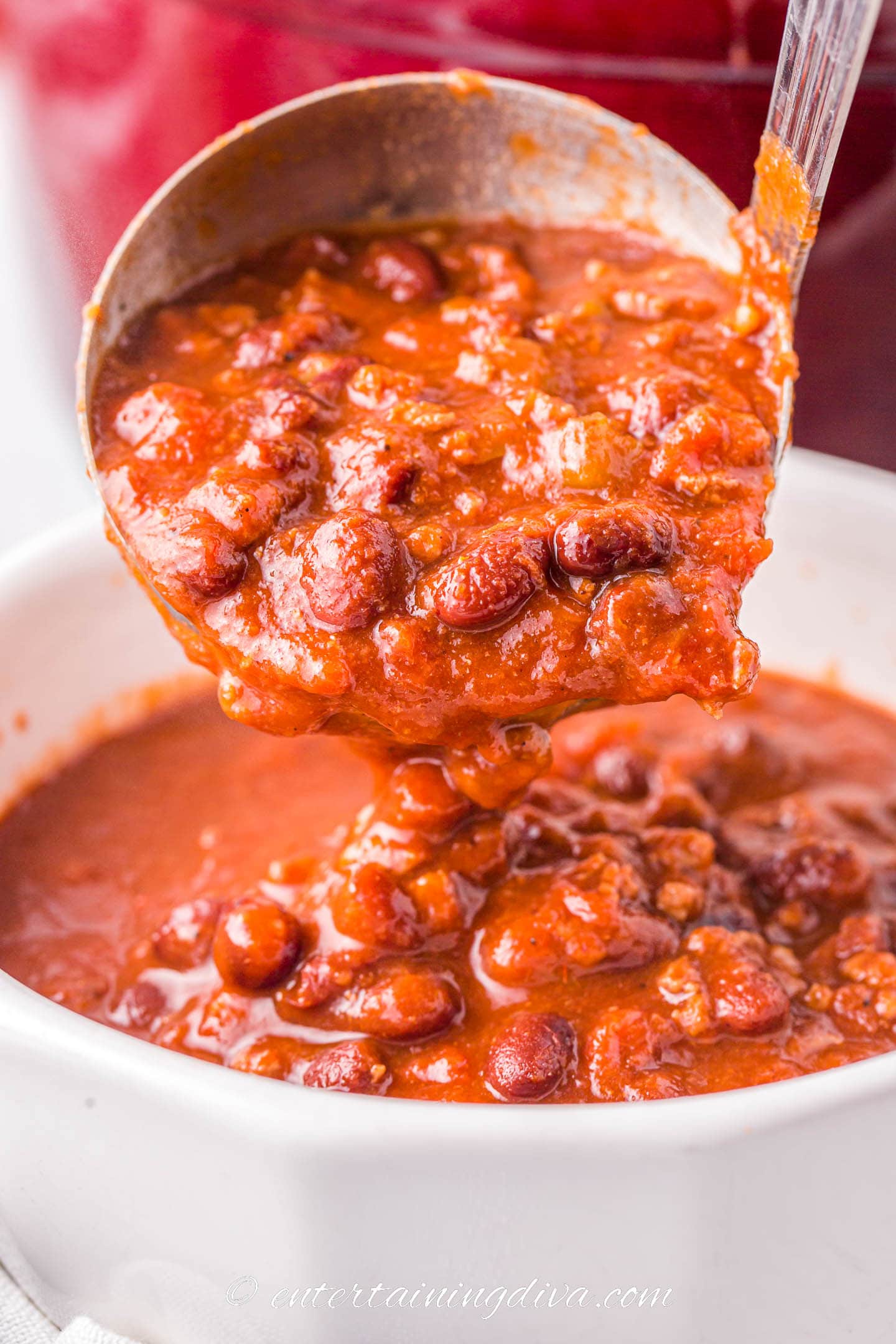 thick chili on a spoon over a bowl