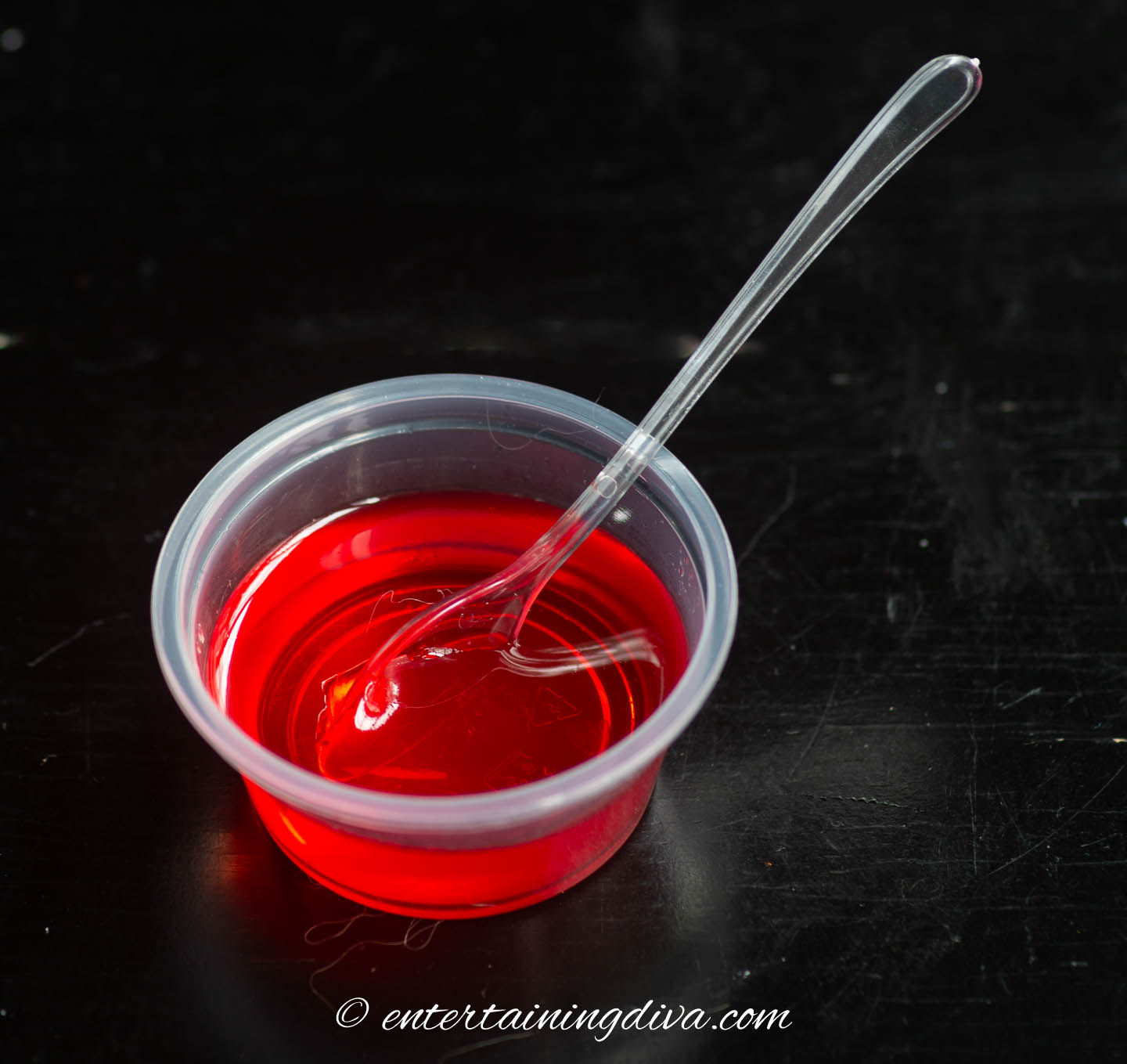 Jello shot in a Jello shot cup with a small spoon