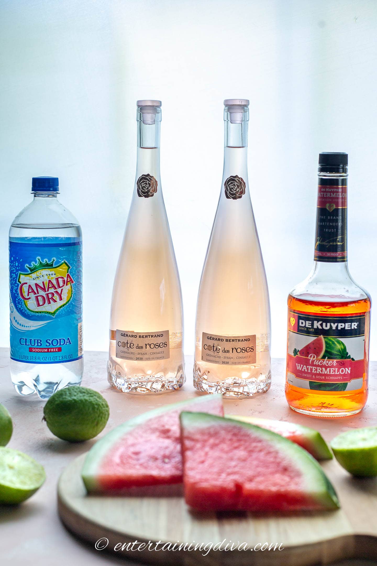 watermelon sangria ingredients - club soda, rose wine, watermelon pucker, limes and fresh watermelon