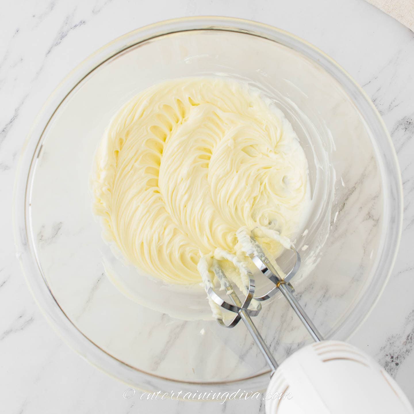 butter being whipped in a bowl