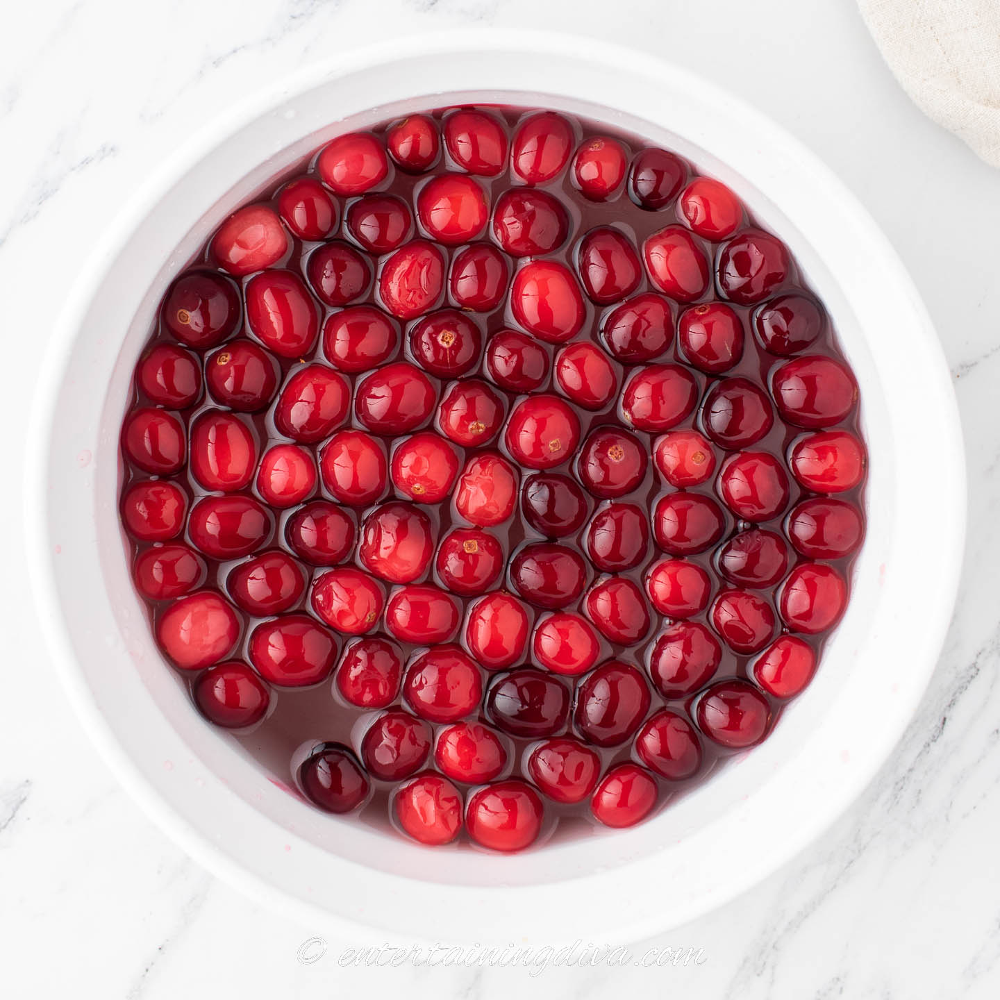 cranberries soaking in sugar syrup