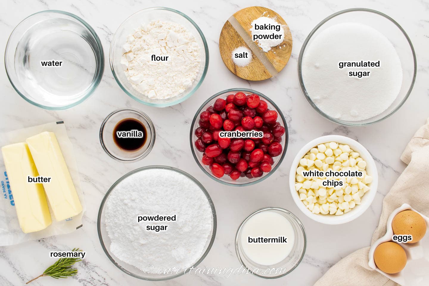 white chocolate cranberry cupcakes ingredients - water, flour, salt, baking powder, sugar, butter, vanilla, cranberries, white chocolate chips, powdered sugar, buttermilk, eggs