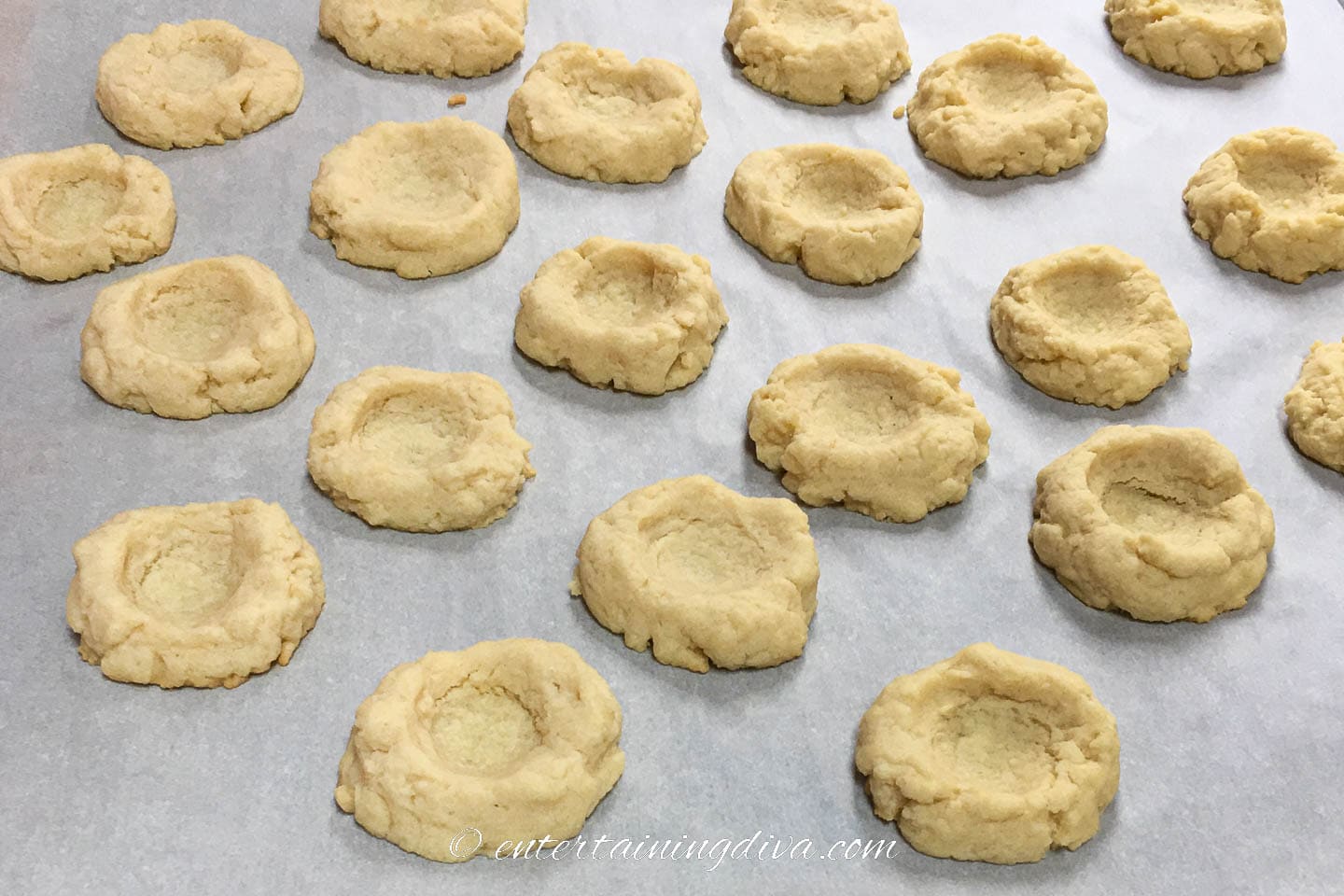 baked thumb print cookies on a baking sheet