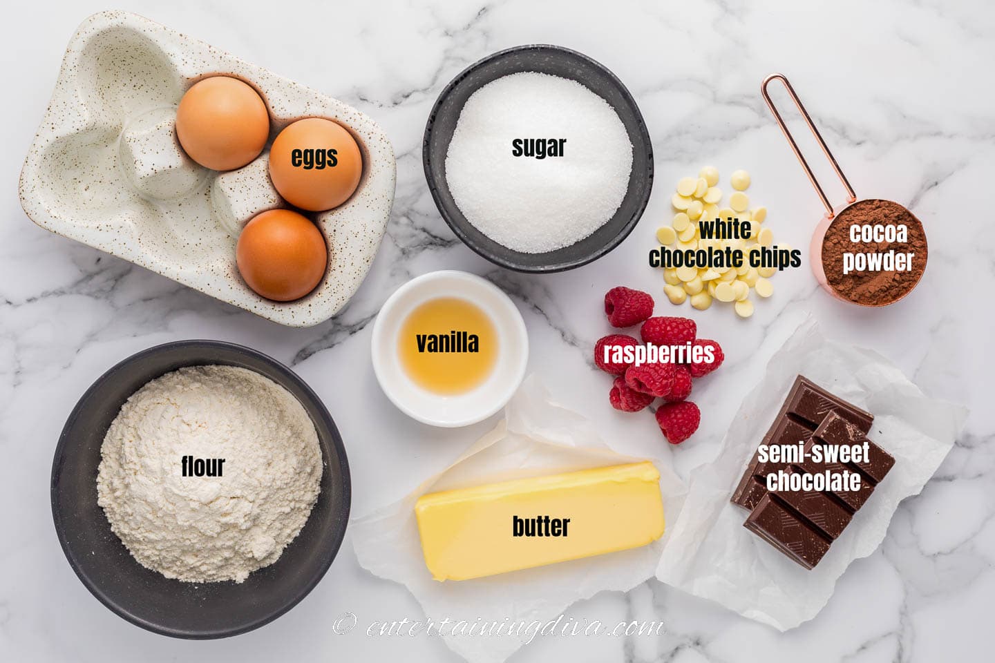 white chocolate raspberry brownies ingredients - eggs, sugar, white chocolate chips, raspberries, cocoa powder, semi-sweet chocolate, butter, vanilla, flour