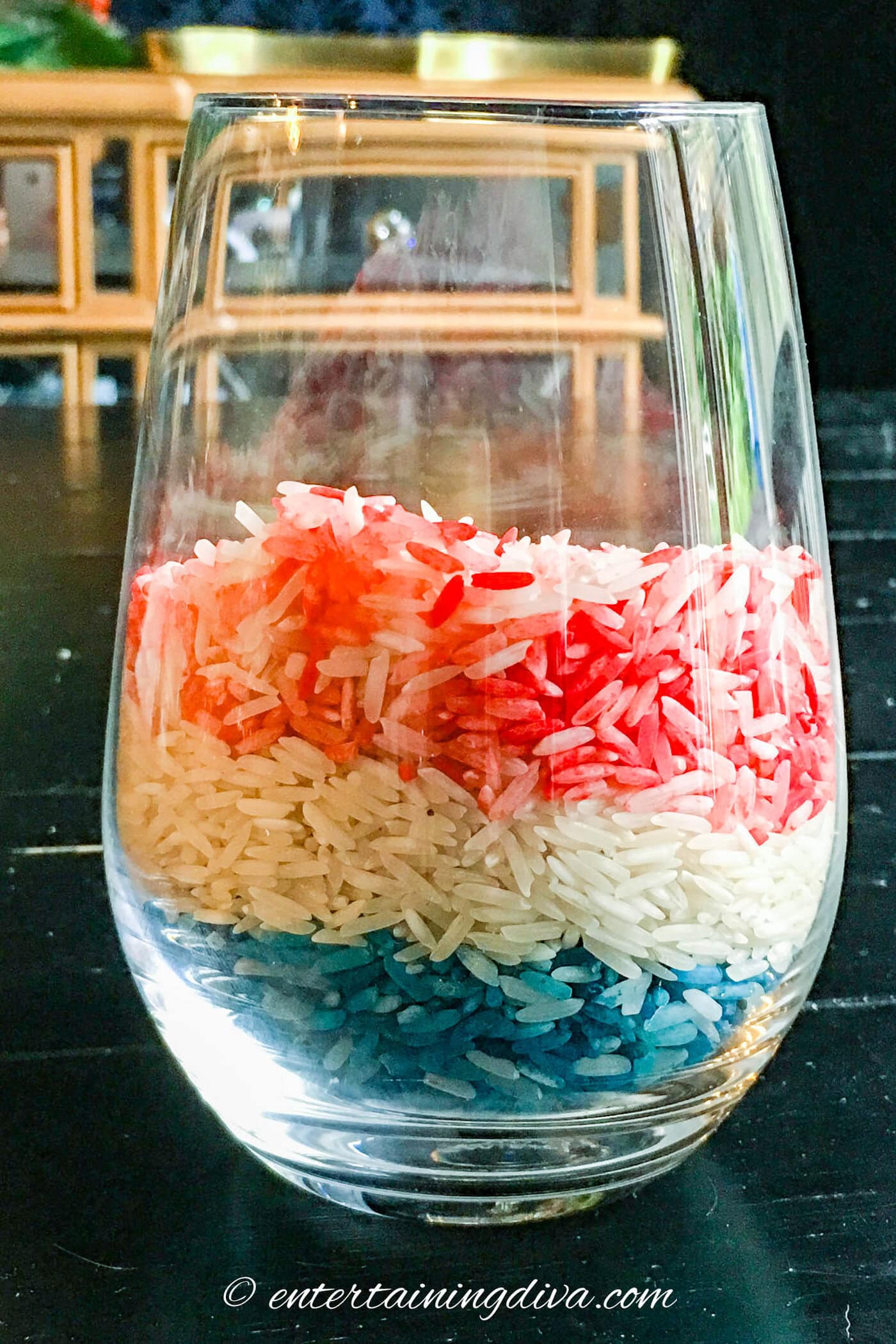 A glass with red, white and blue layers of rice in it