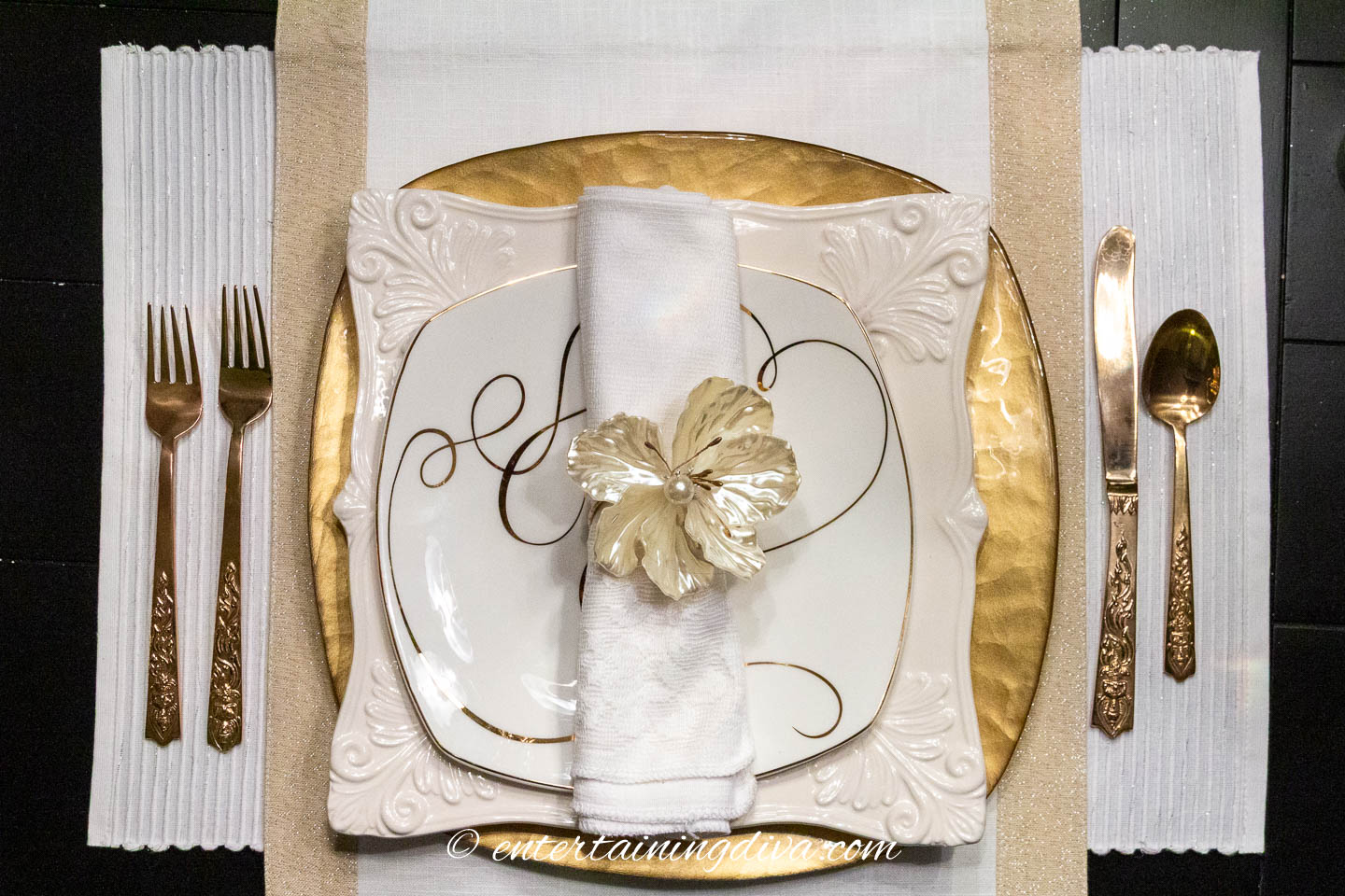 Gold and white accent plate on a white dinner plate, gold charger on a gold and white runner