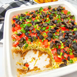 7-layer dip with part of it eaten showing the layers