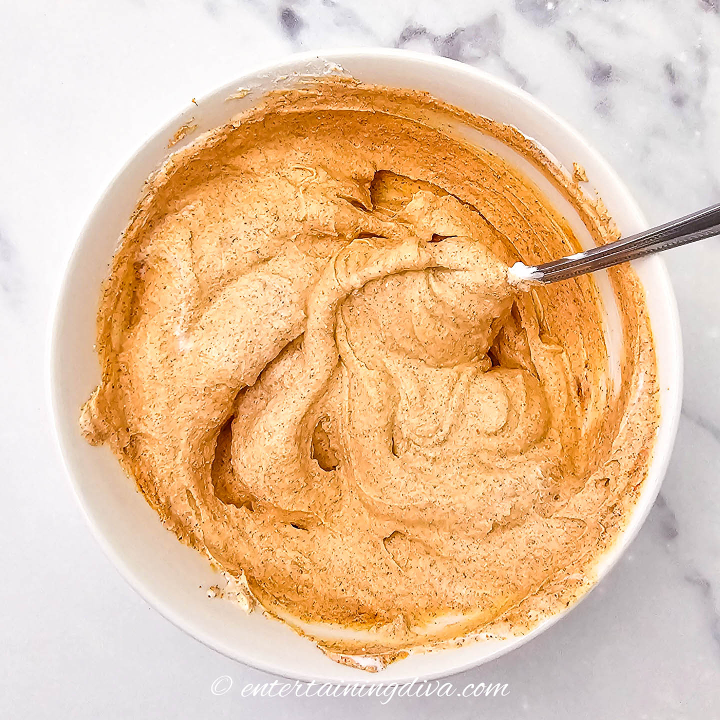 sour cream mixed with taco seasoning in a bowl