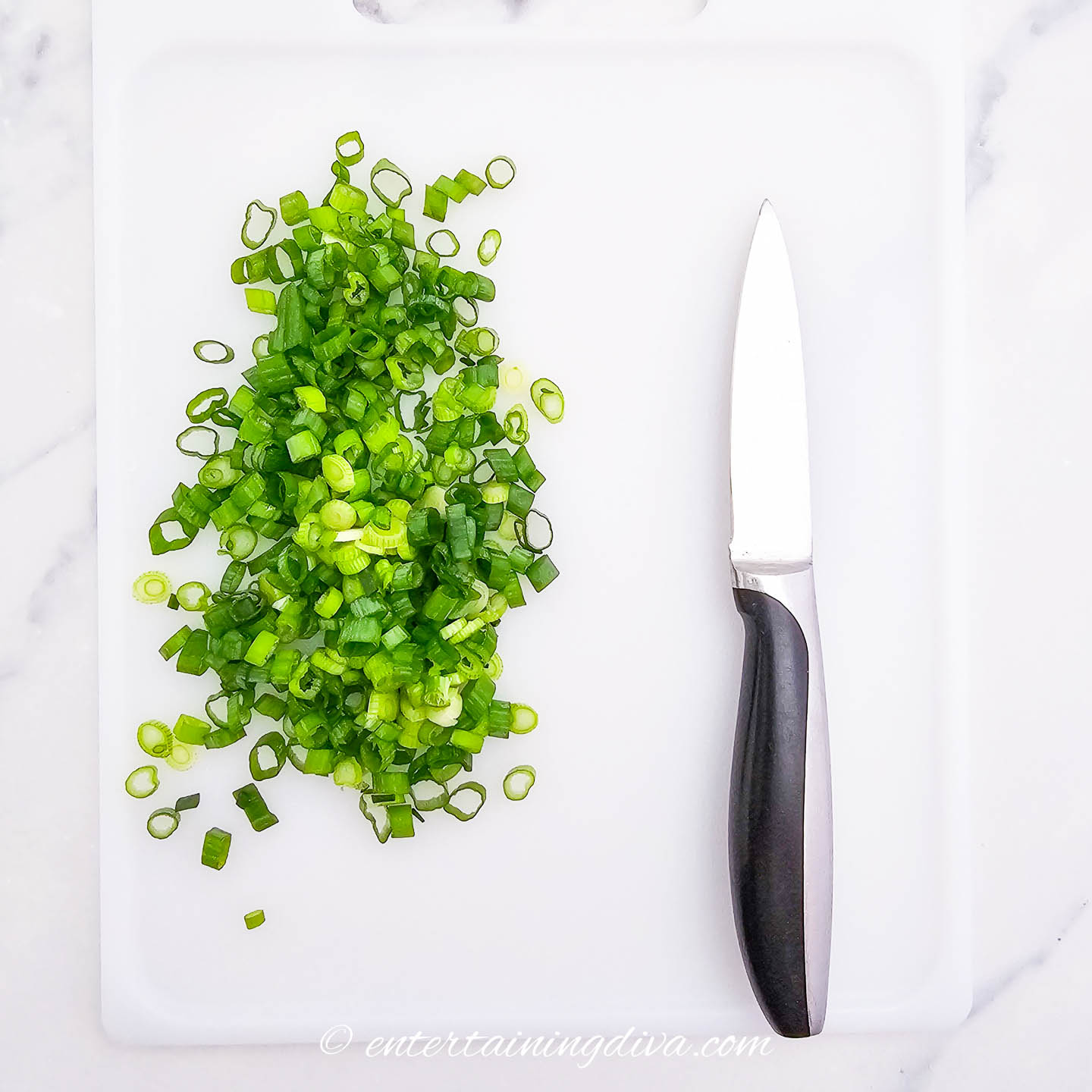 chopped green onions on a cutting board