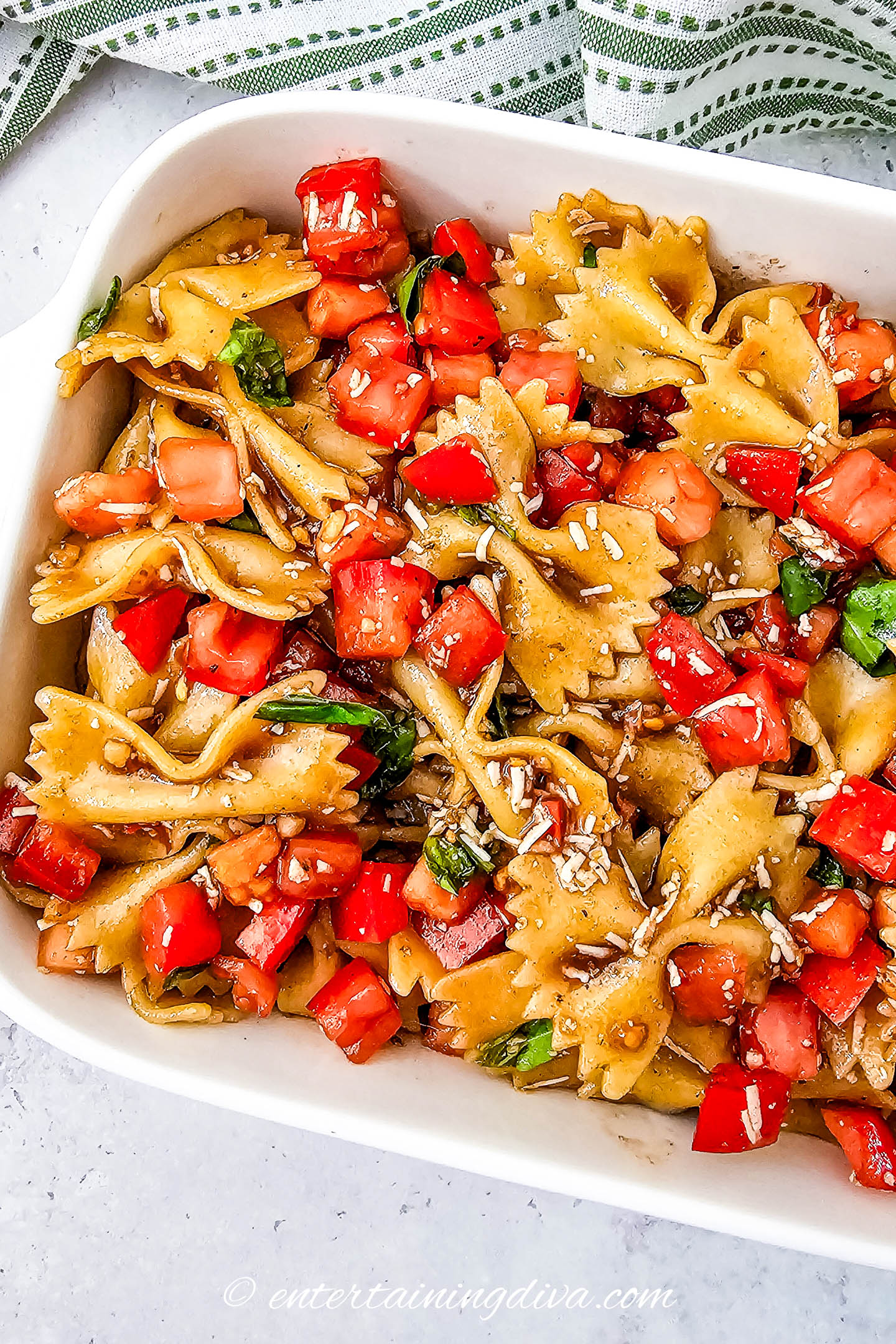 Bruschetta pasta salad in a white serving dish