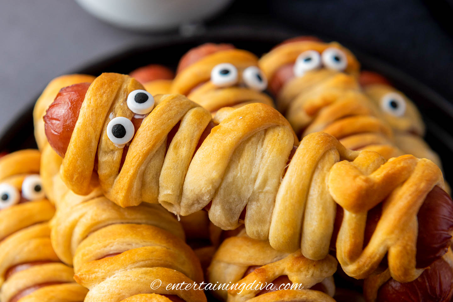 Close up of a Halloween mummy dog on top of a stack of them