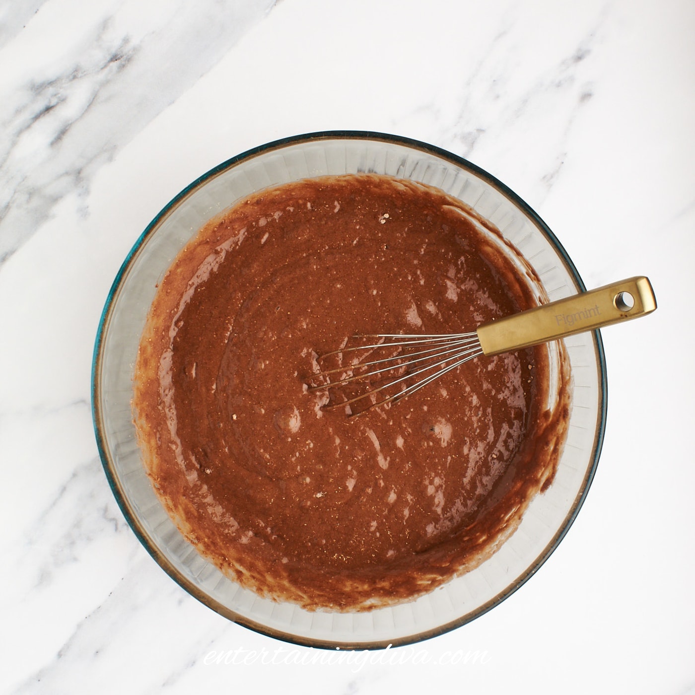 Chocolate cupcake batter mixed in a glass bowl