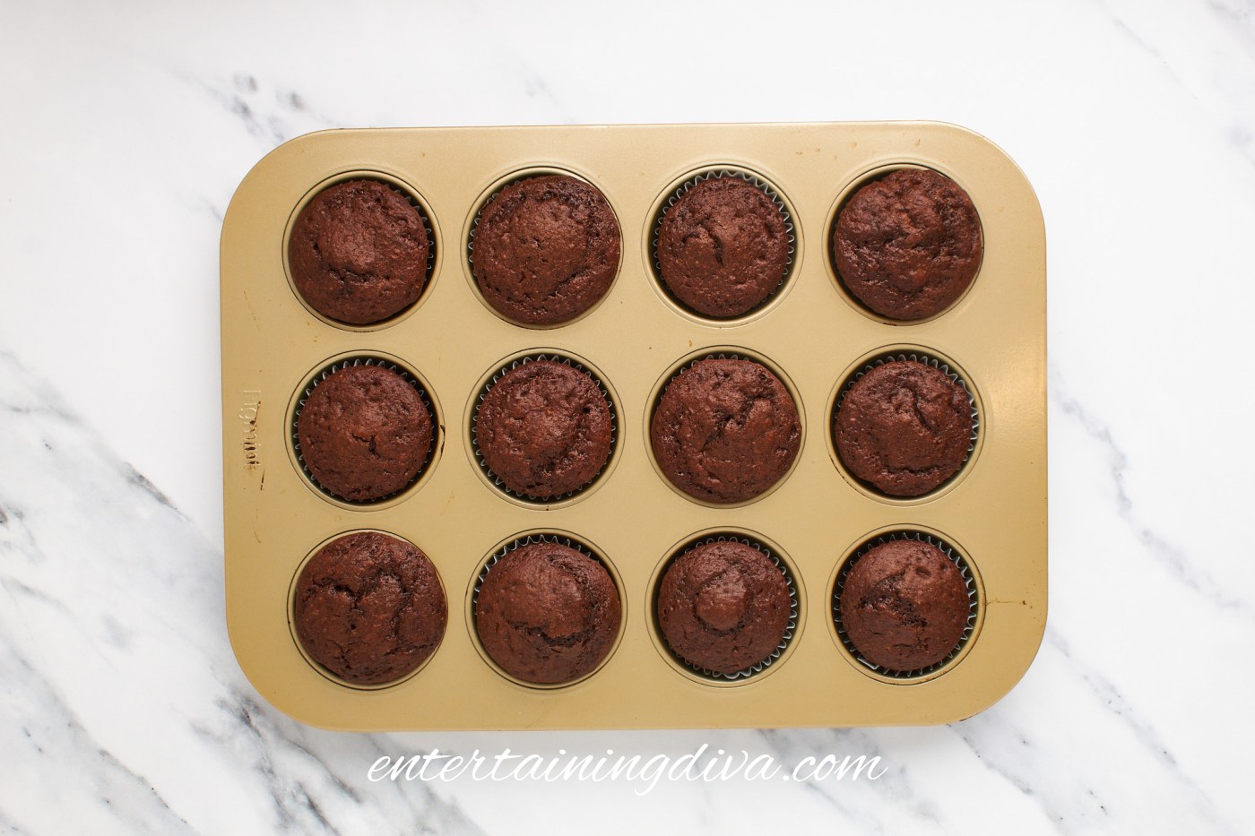 Baked chocolate cupcakes cooling in a muffin tin