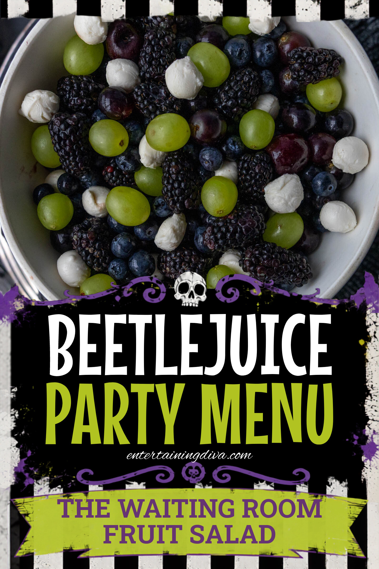 A bowl containing green grapes, blackberries, blueberries, dark cherries, and small mozzarella balls.