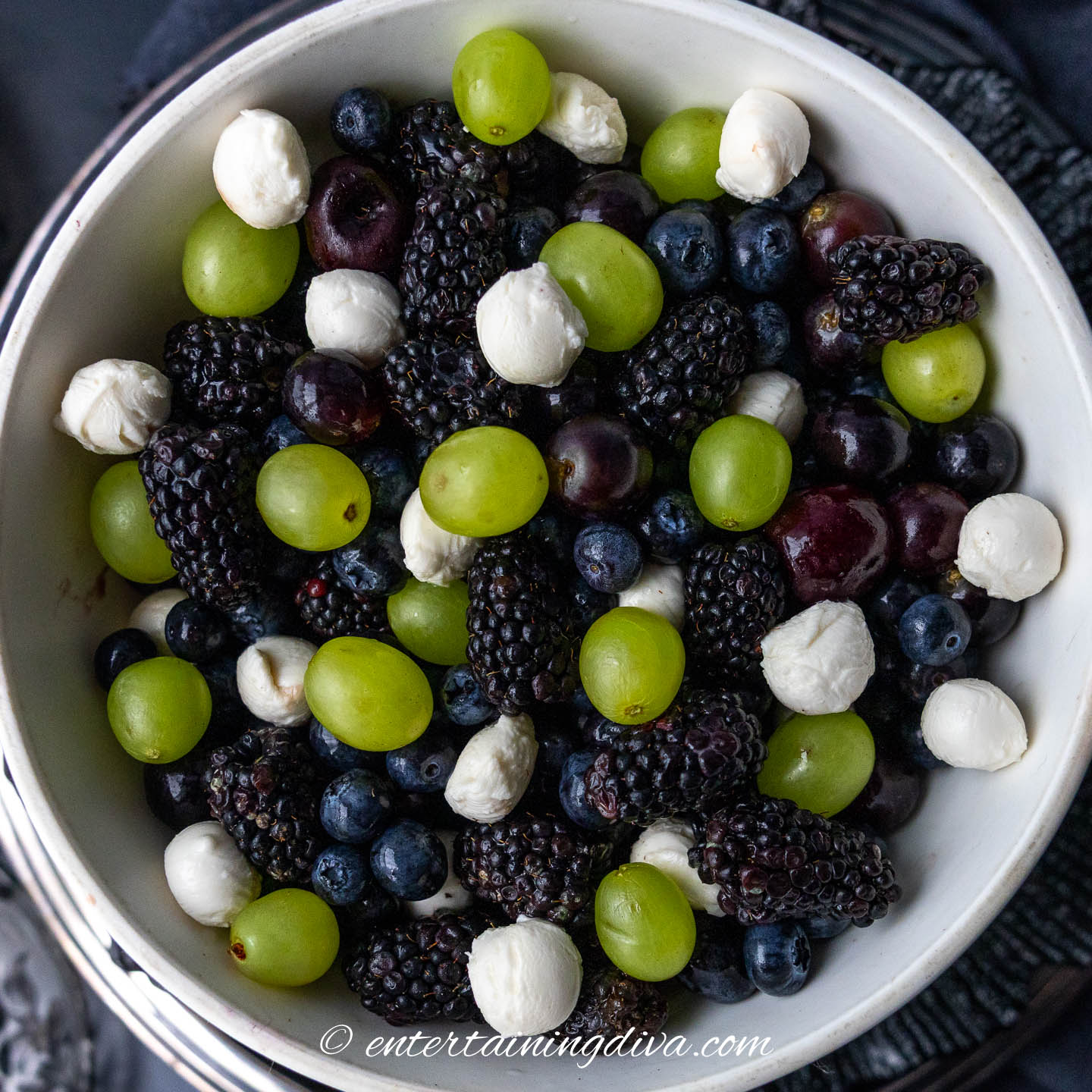 dark fruit salad with green grapes and white mozzarella pearls