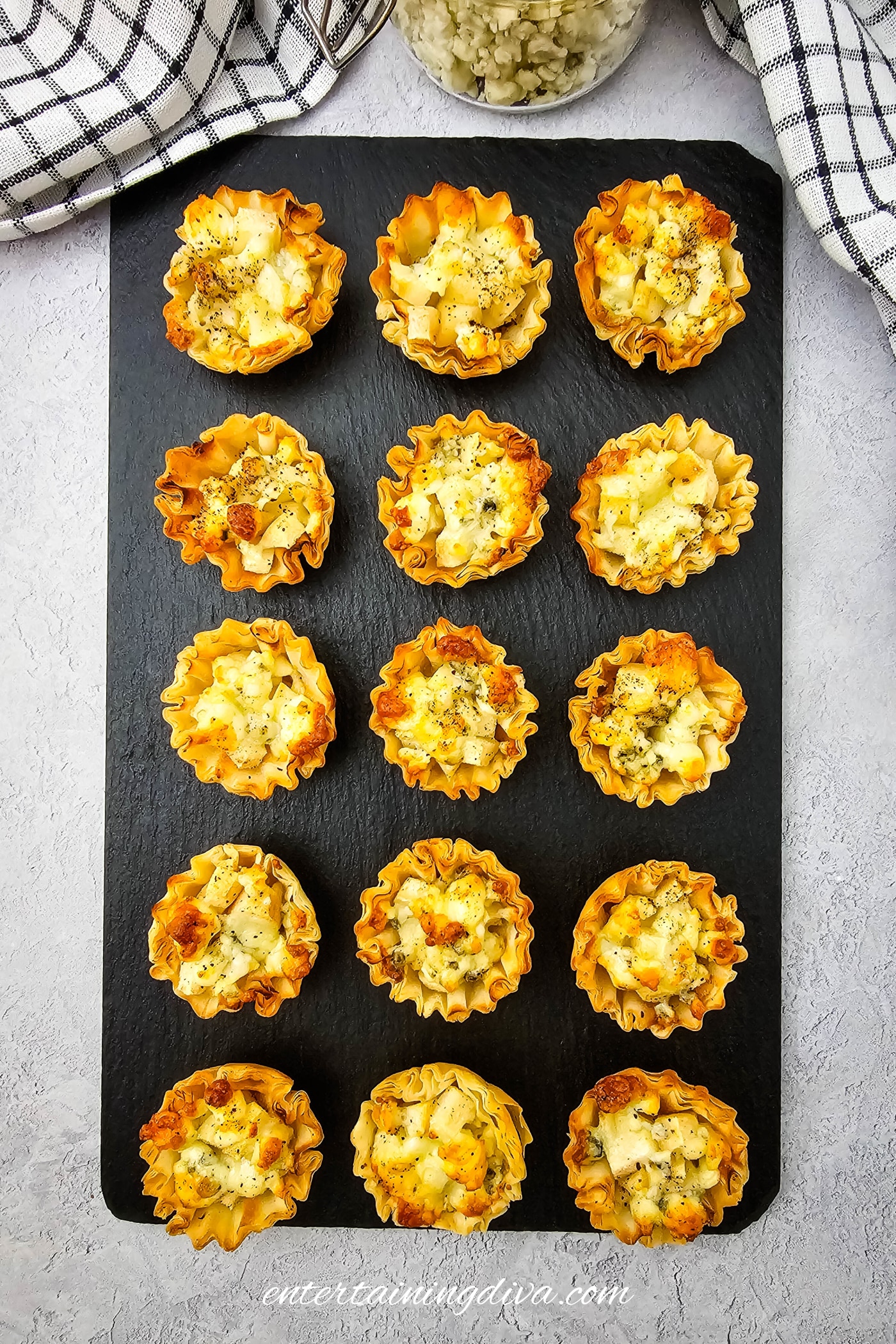Blue cheese and pear phyllo bites on a serving plate