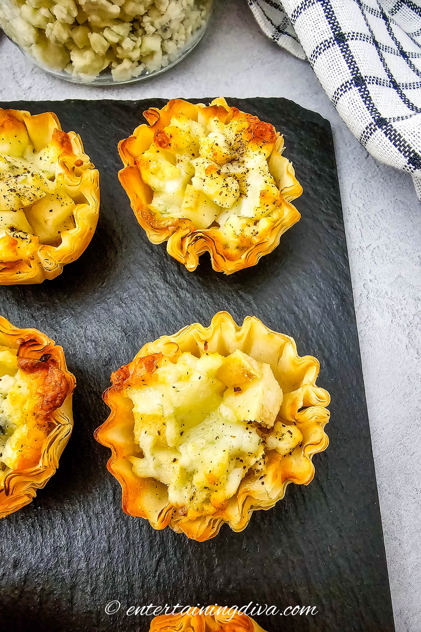 Close up of blue cheese and pear tartlets on a serving tray