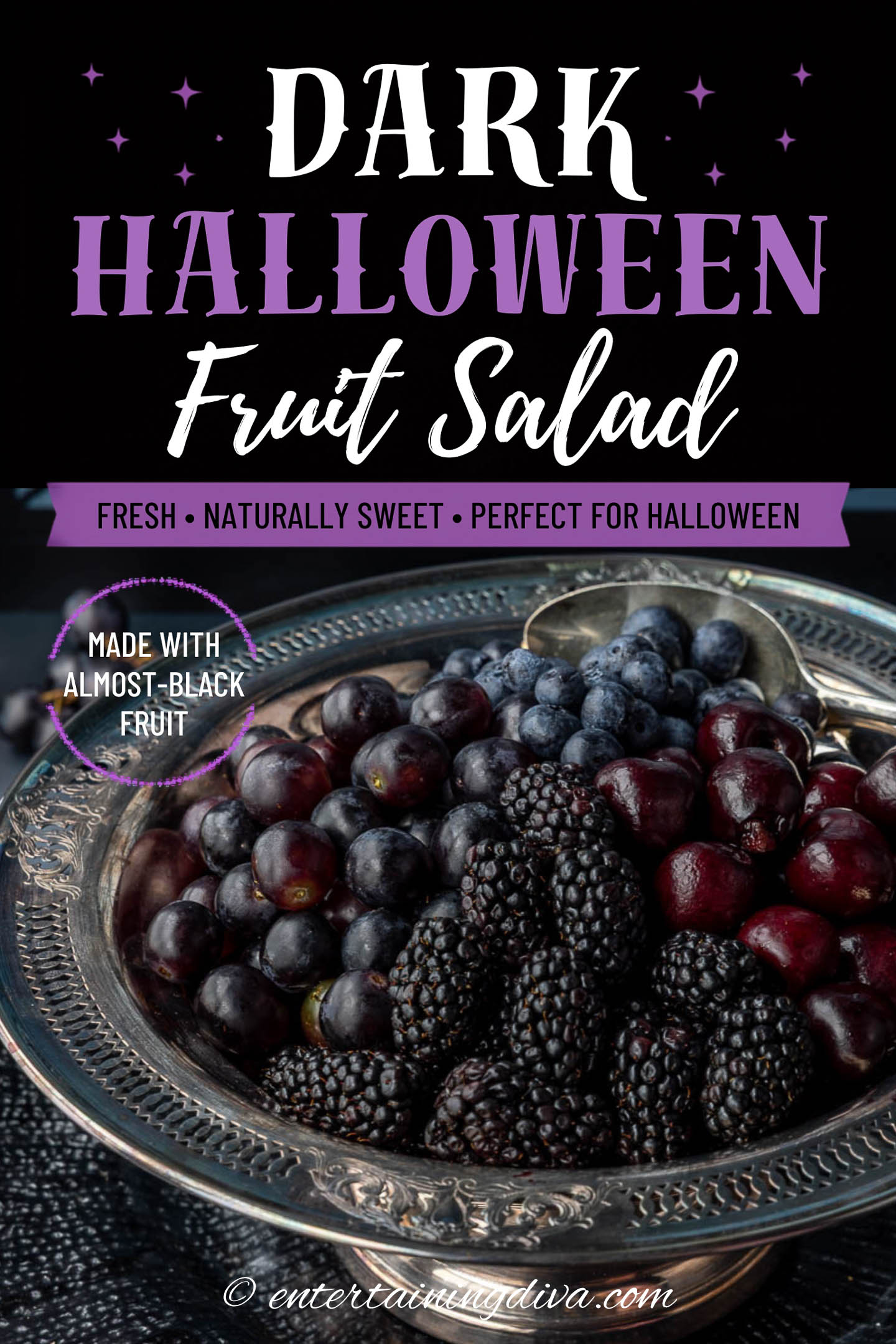 Close up of a bowl of blackberries, cherries, grapes and blueberries with the text "Dark Halloween Fruit Salad" across the top