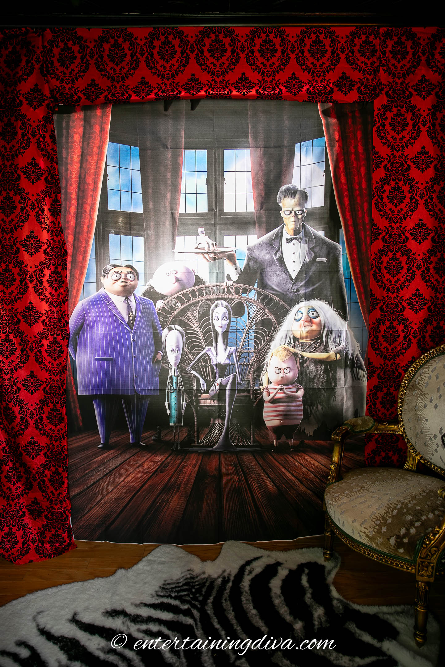Addams family scene setter hung in front of a closet with backlighting