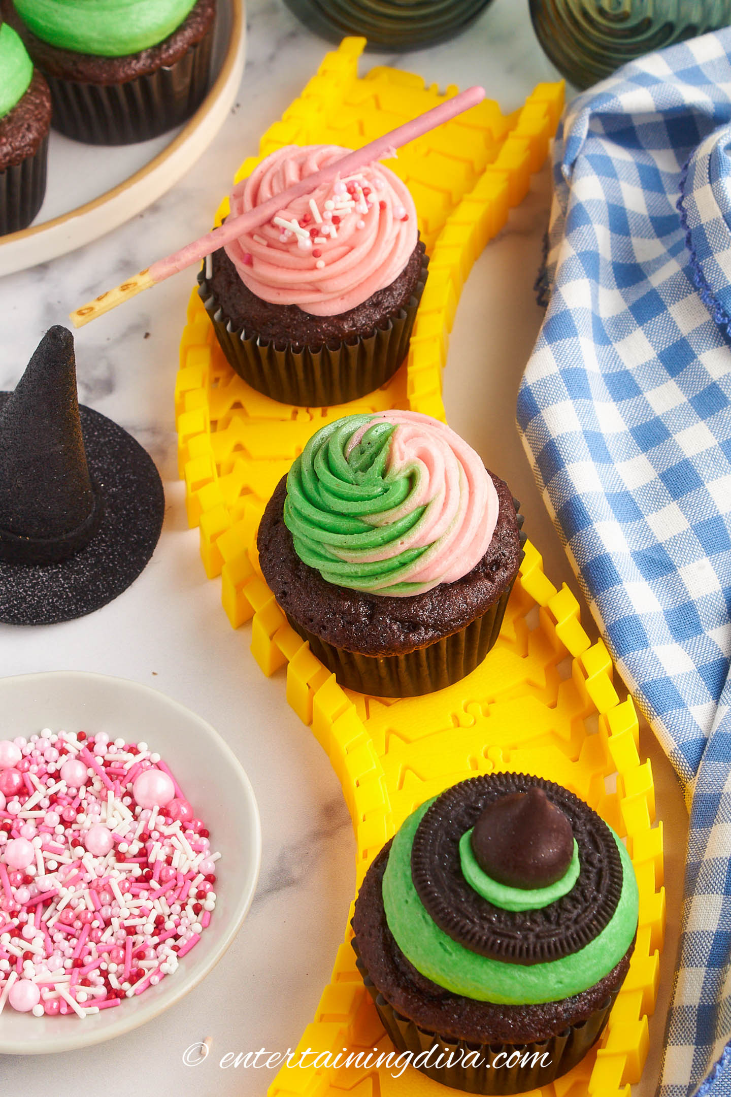 Three Wicked cupcakes - a green on for Elphaba, pink one for Glinda and a pink and green one
