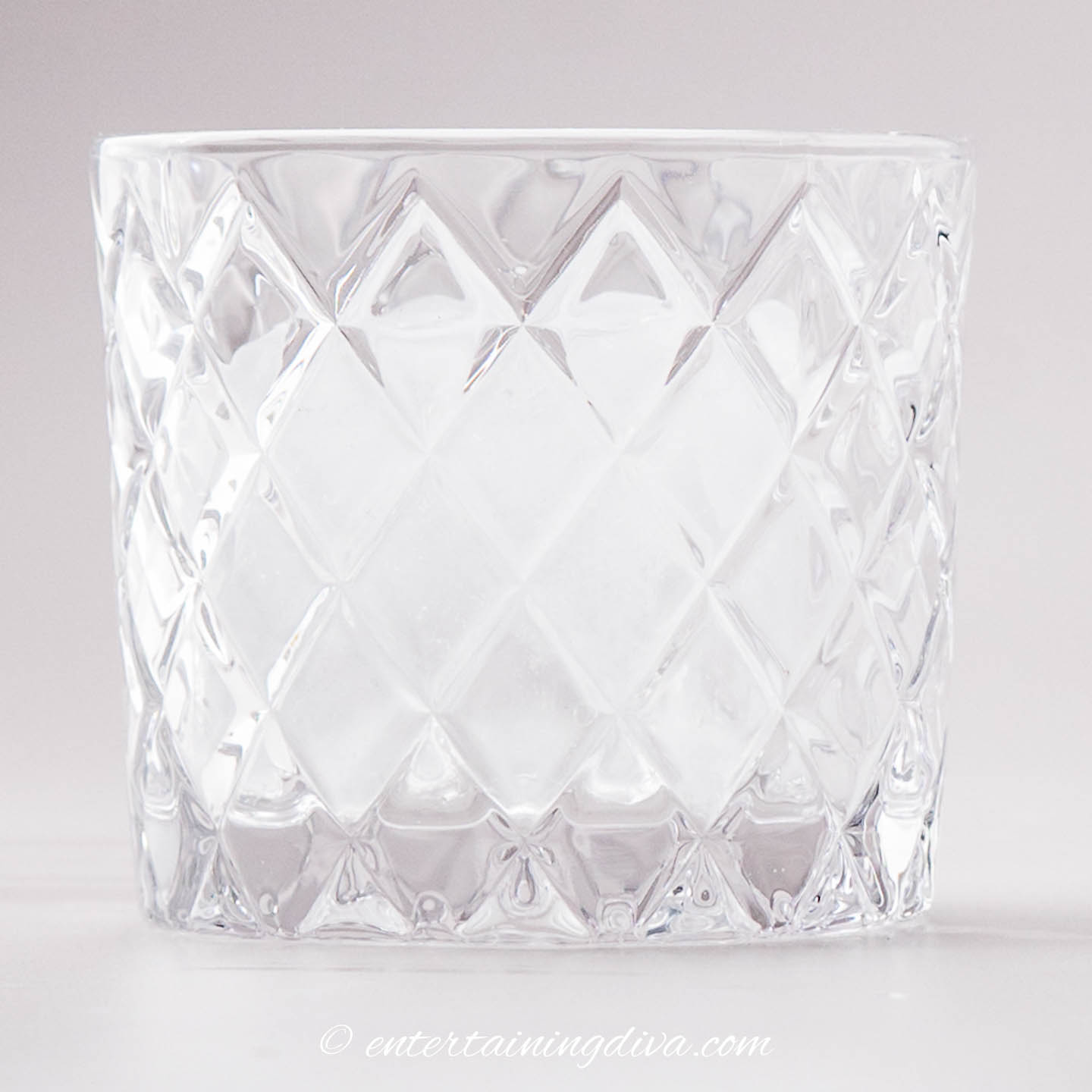 A large ice cube in an Old Fashioned glass