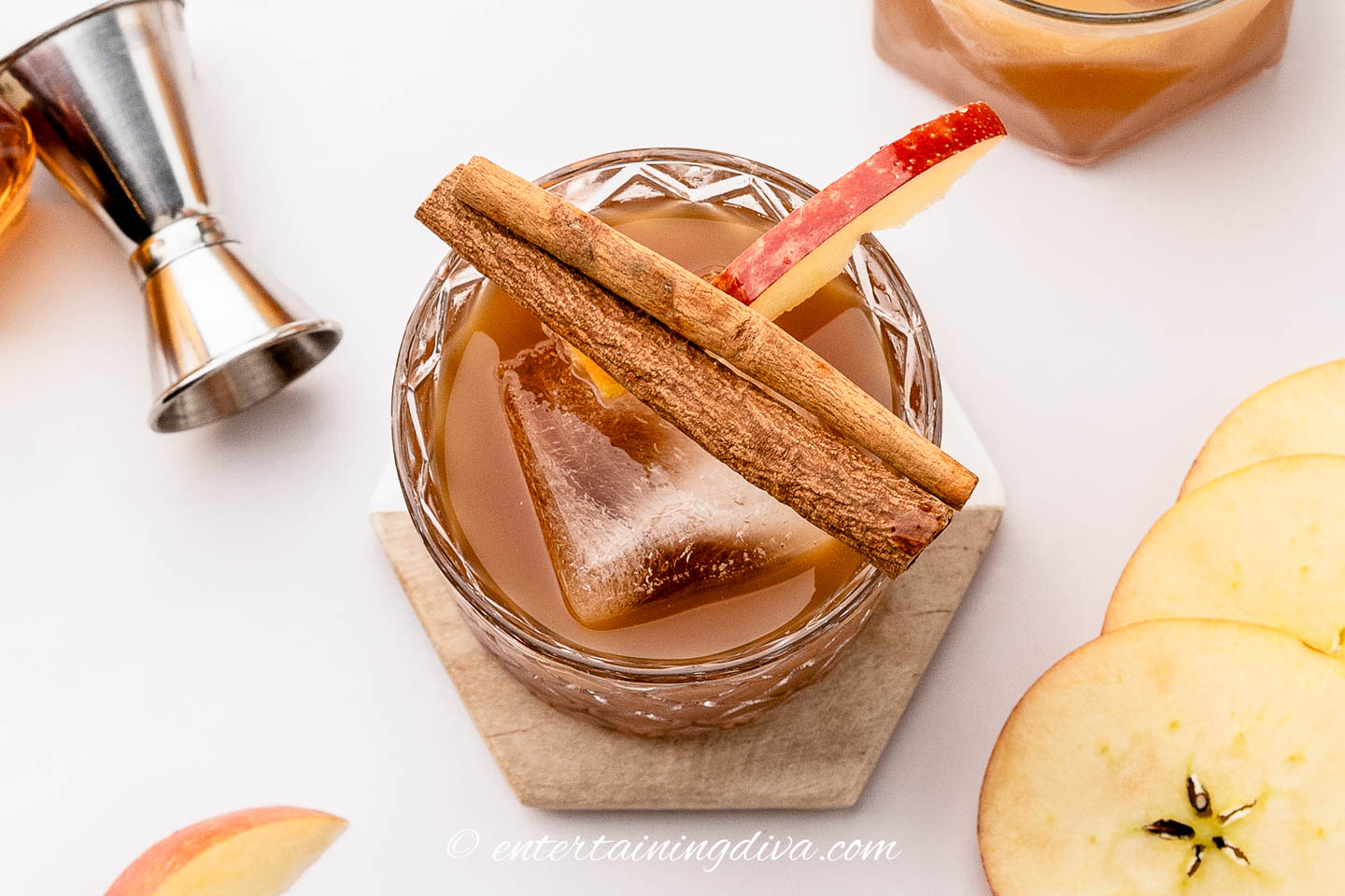 Overhead picture of an apple butter old fashioned garnished with cinnamon sticks and an apple wedge