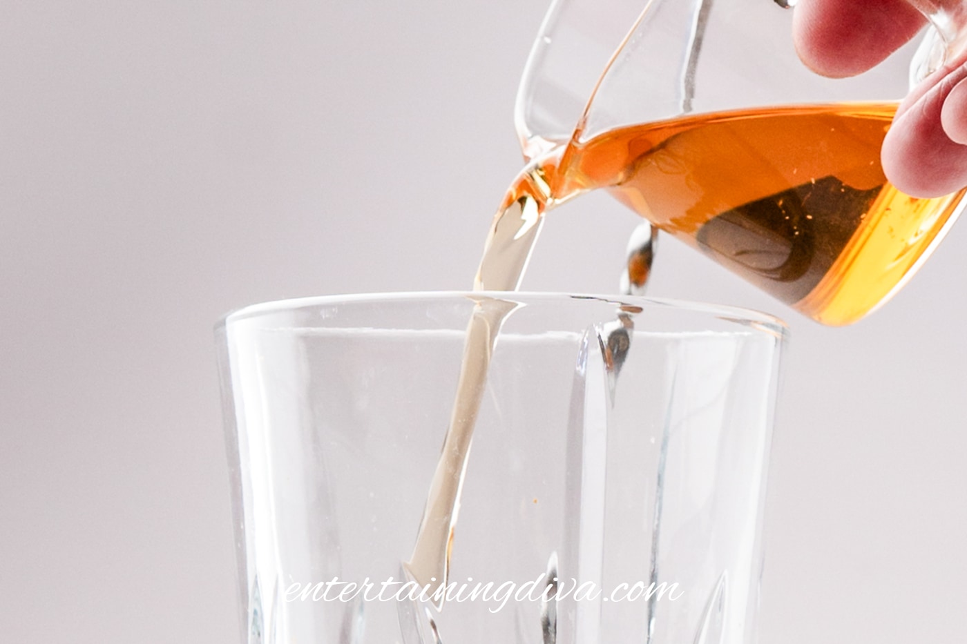 Bourbon being poured into a shaker