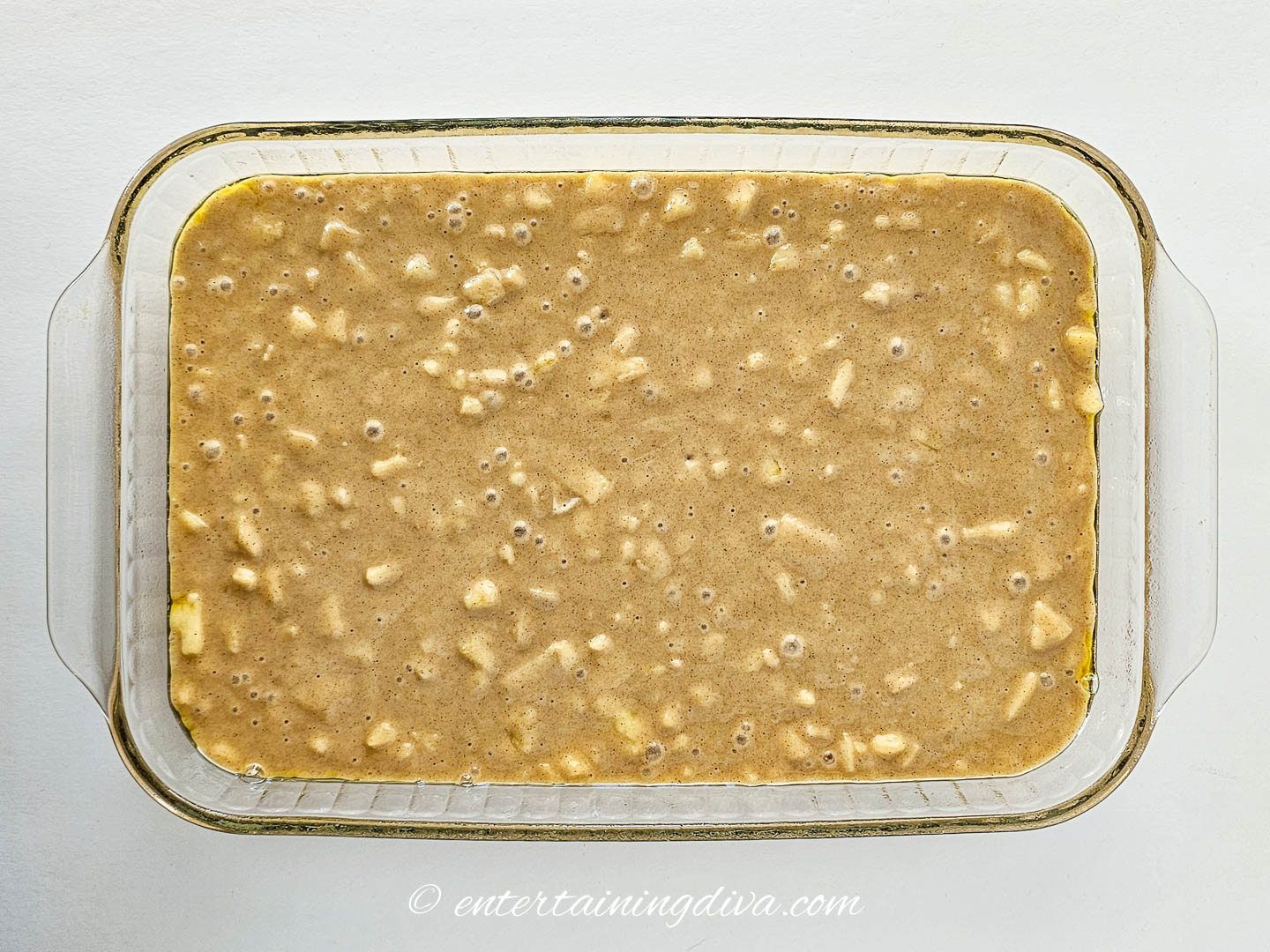 apple cake batter in a 9x13 baking pan