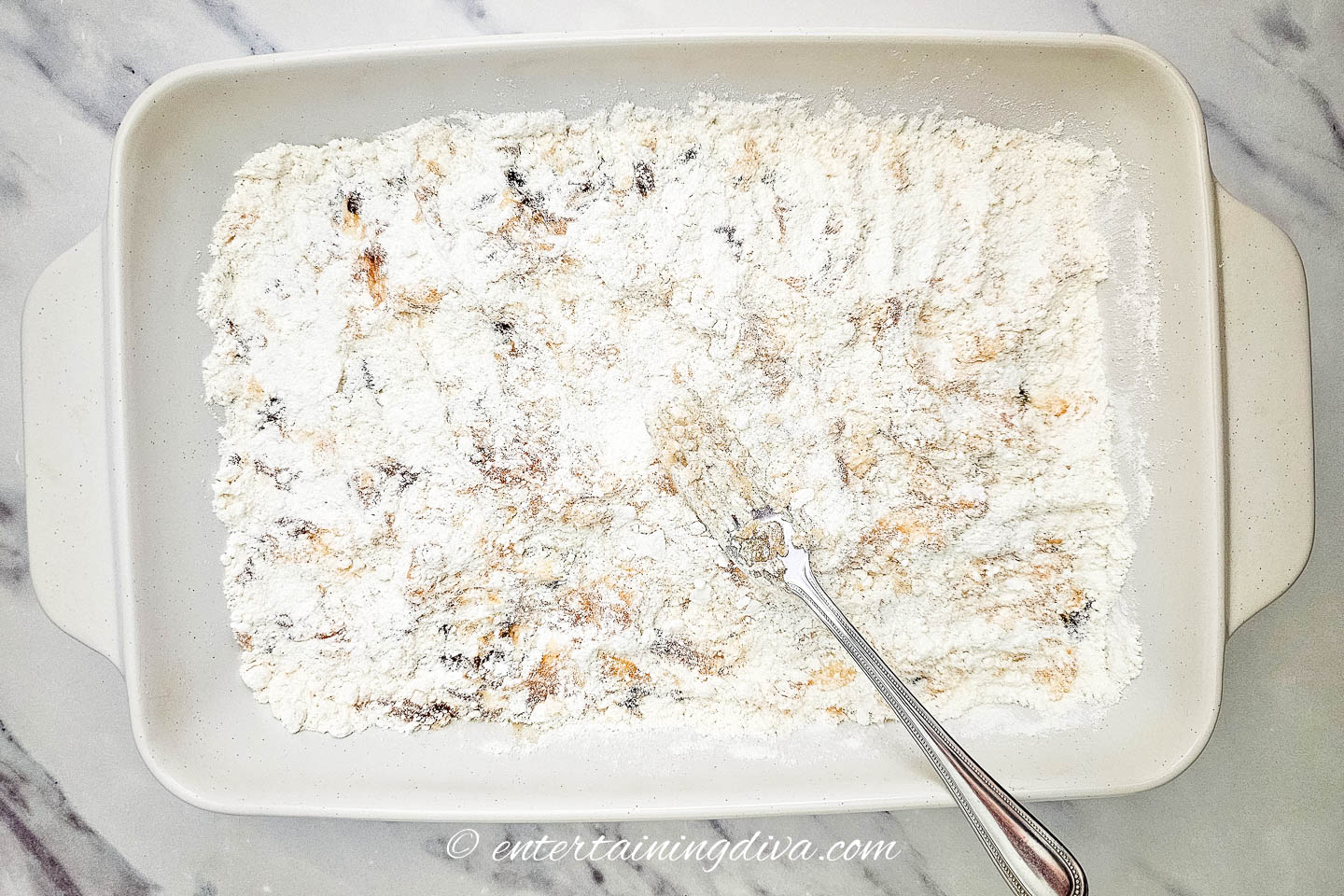 cake mix spread over apple pie filling in a 9x13 baking dish