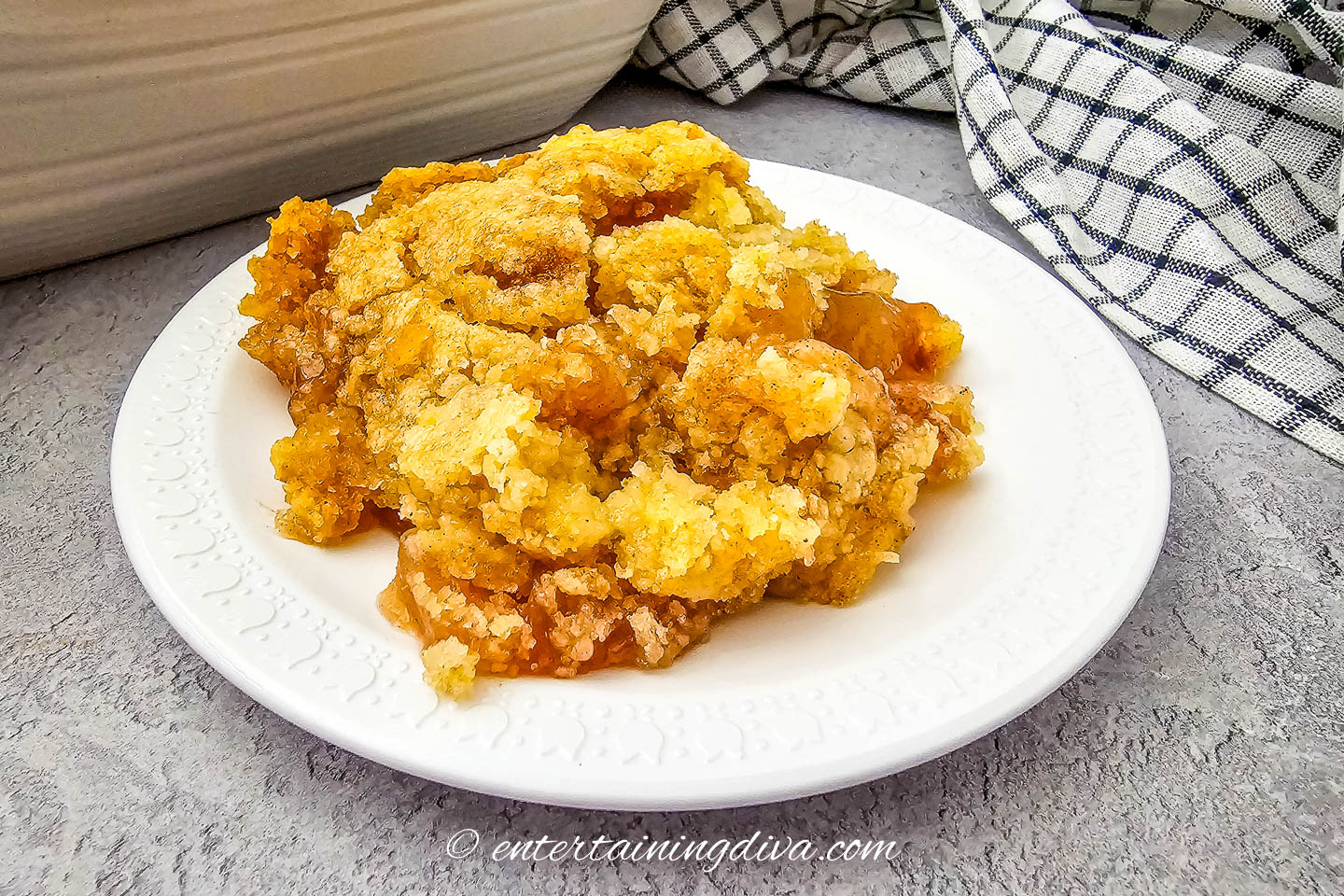 Side view of easy apple cobbler on a white plate