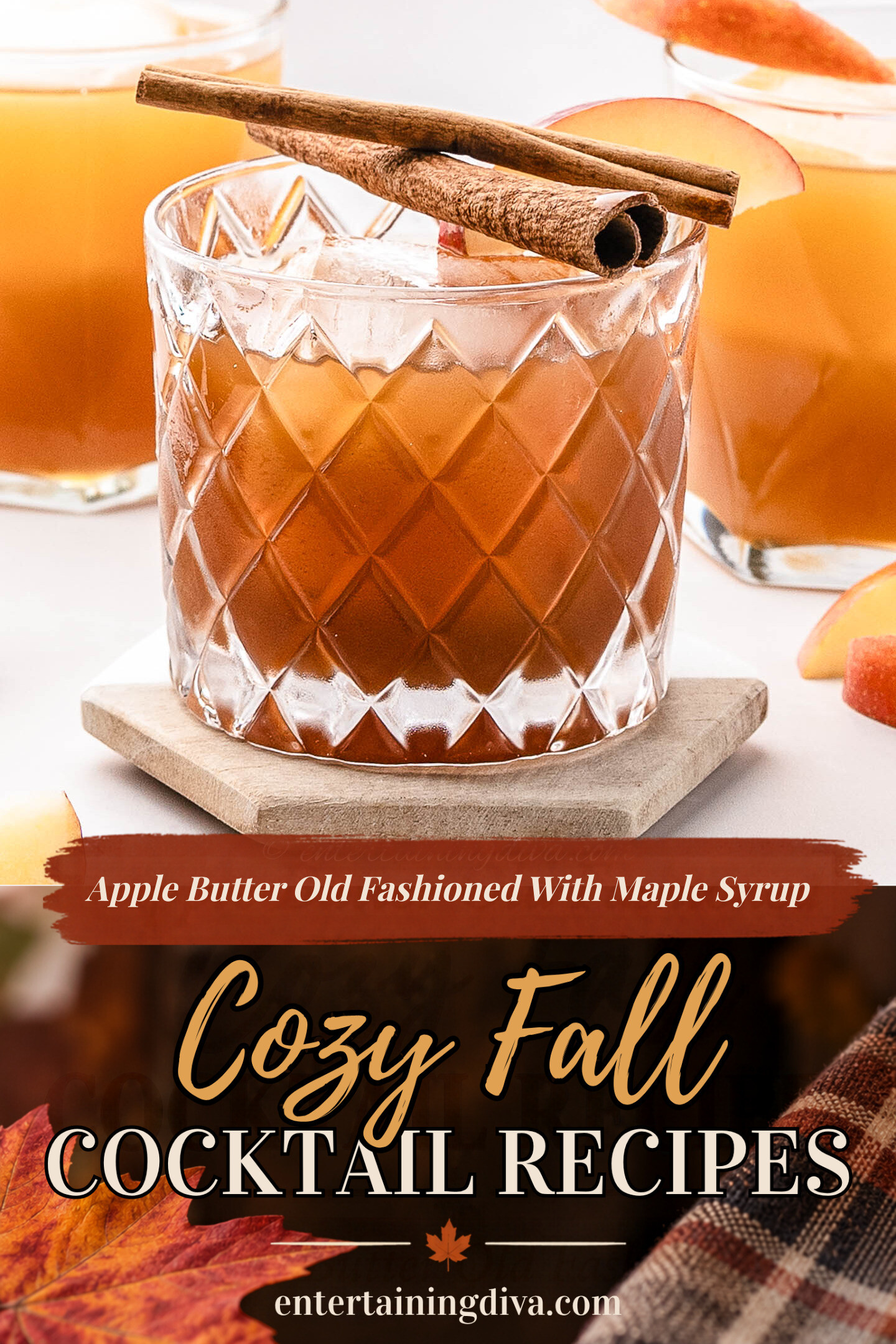 A glass of iced apple cider garnished with two cinnamon sticks, with apple slices and more drinks in the background.