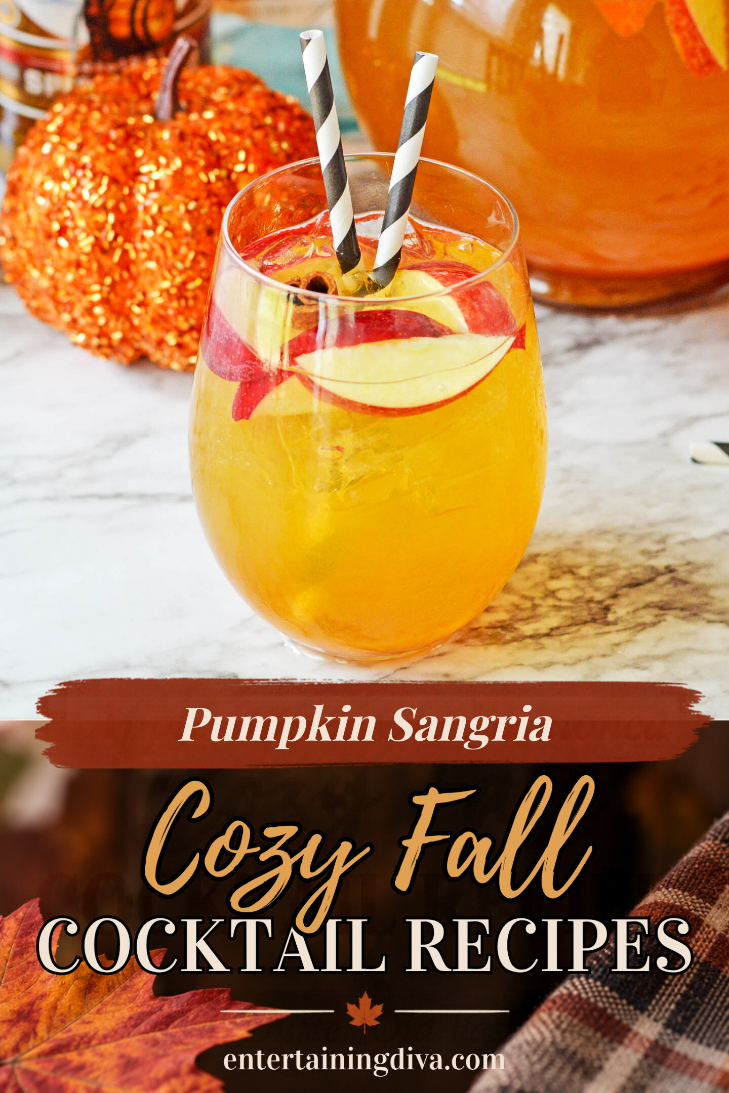close up of a glass of pumpkin sangria garnished with apple slices, a cinnamon stick and two straws