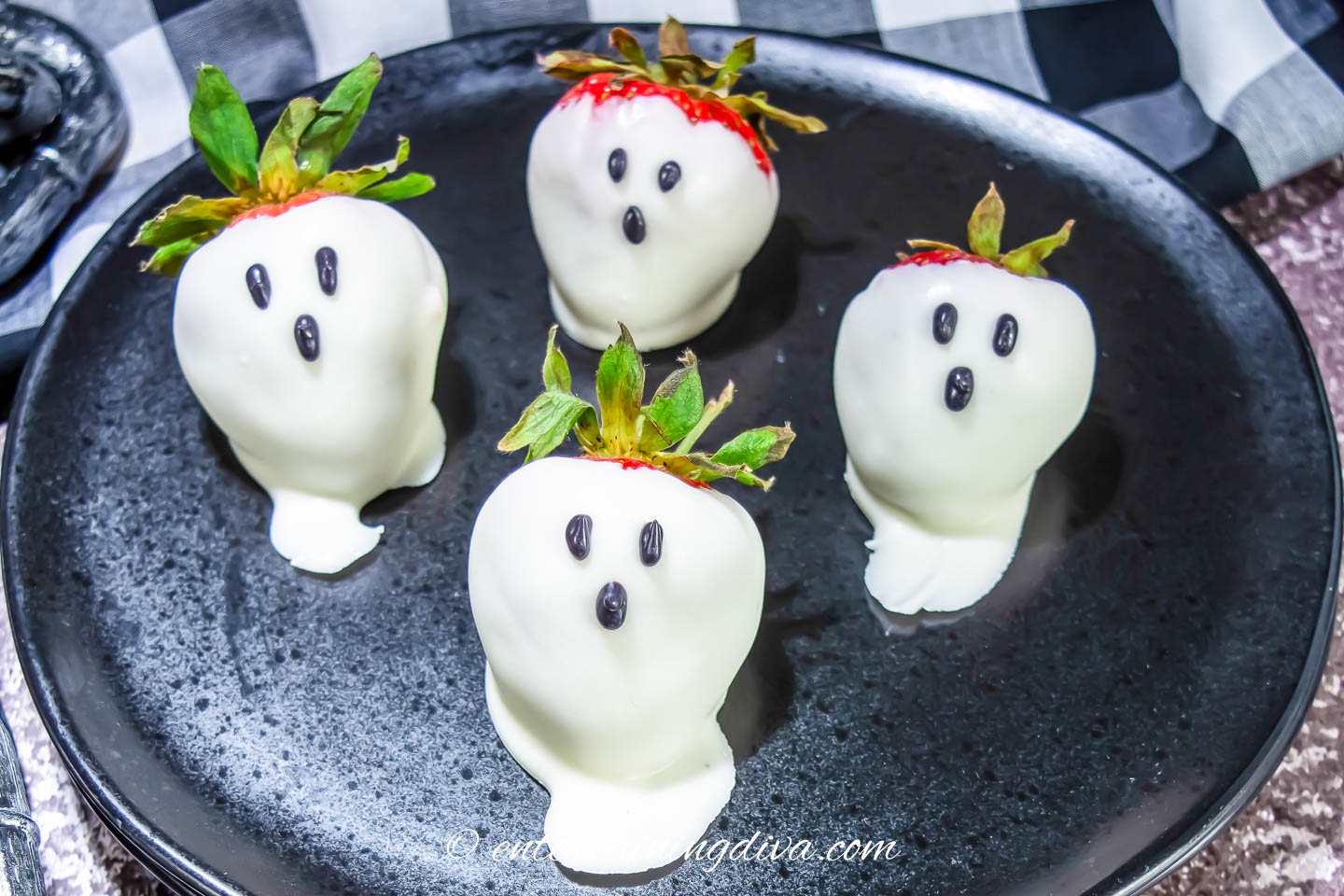 close up of 4 ghost strawberries on a plate