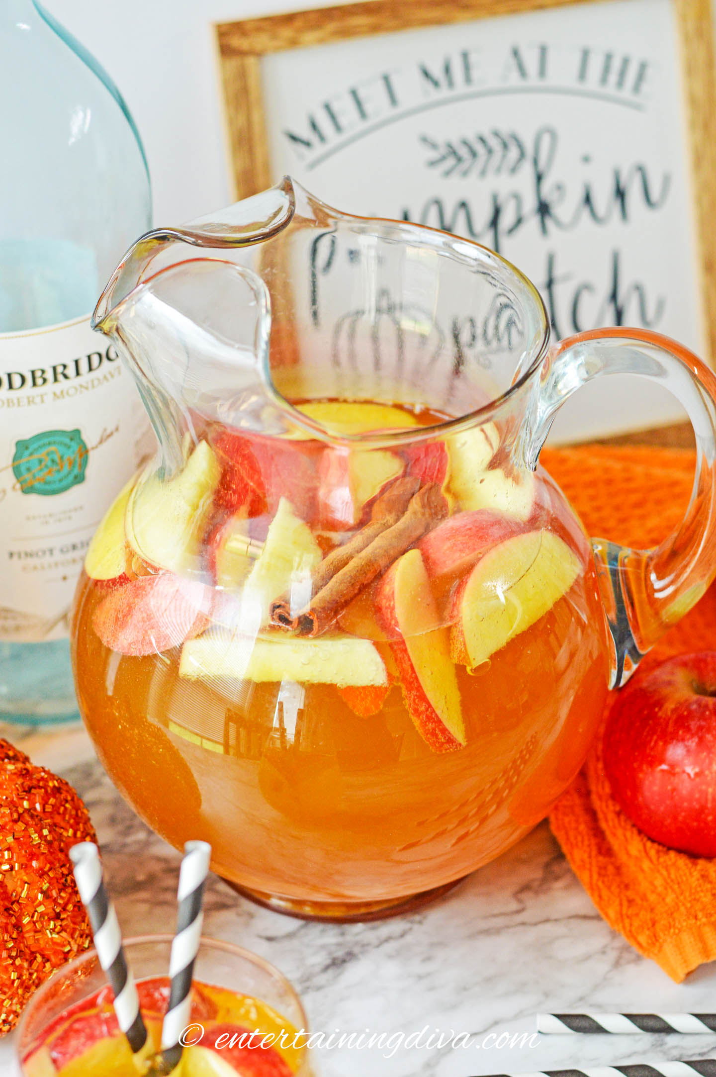 A pitcher of pumpkin sangria in front of a pumpkin patch sign