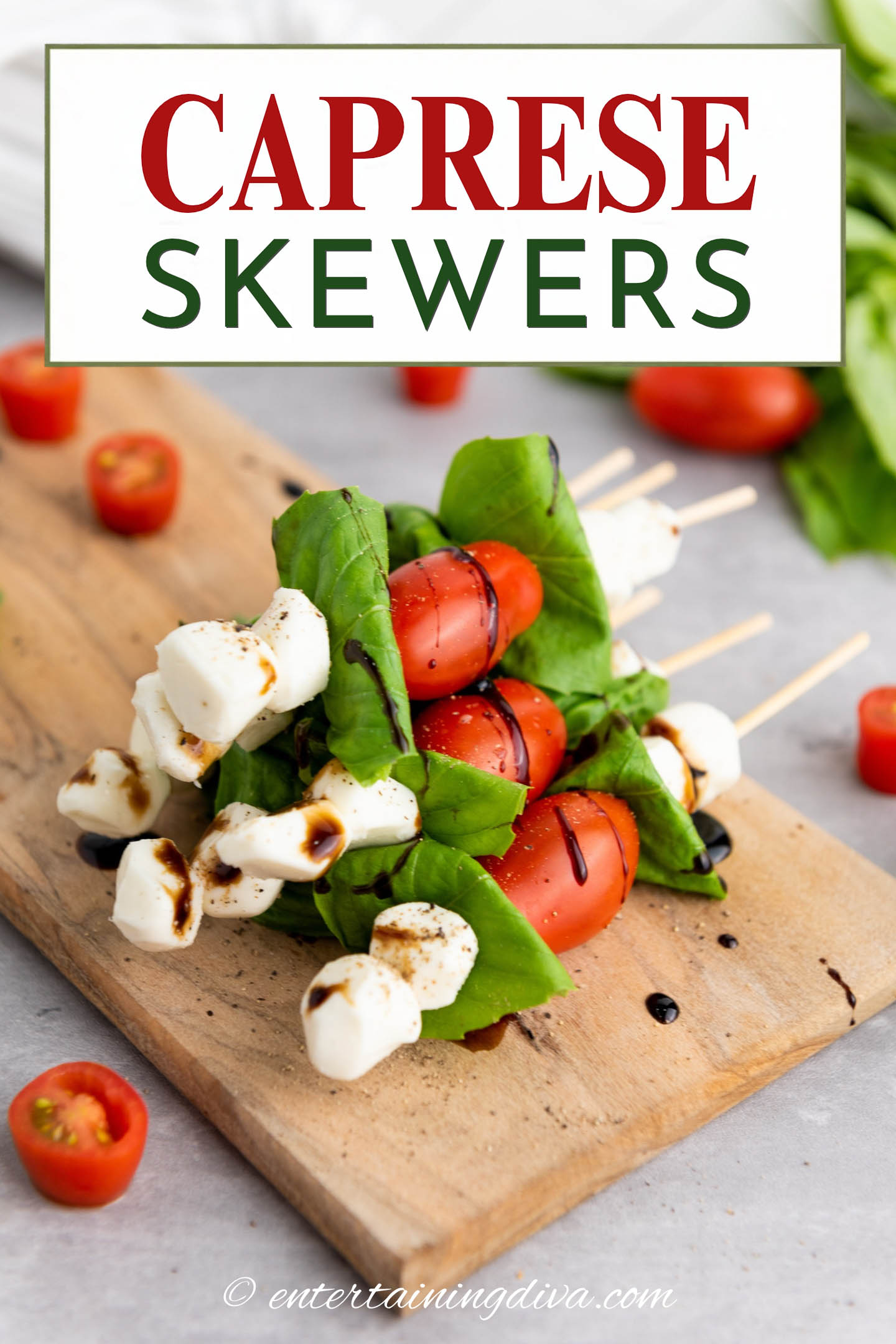 A stack of caprese skewers with balsamic glaze and the text CAPRESE SKEWERS written across the top