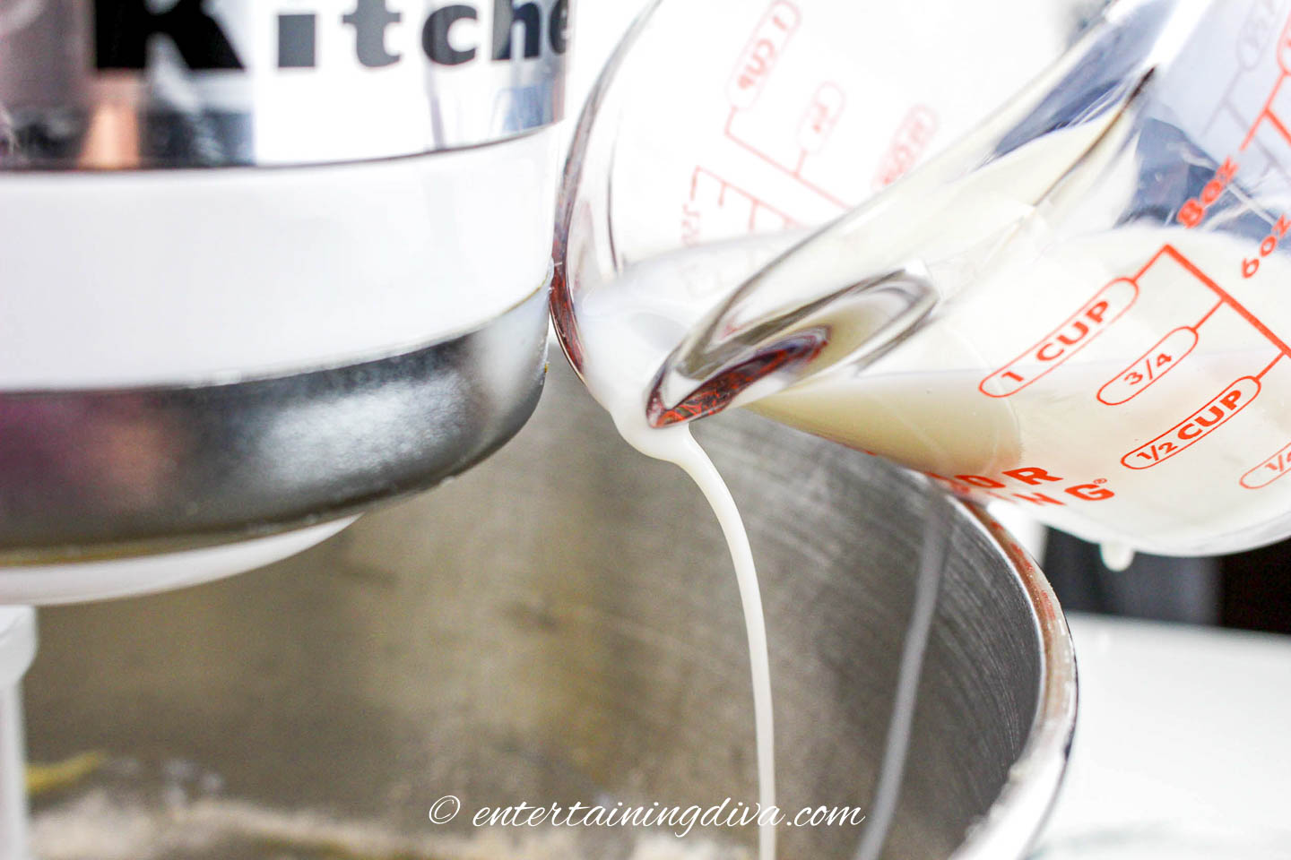 milk being added to the caramel apple sheet cake batter