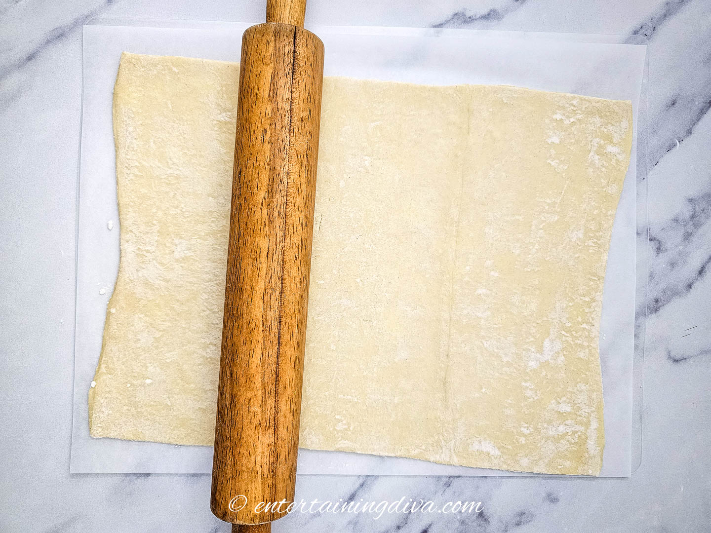 phyllo dough being rolled out with a rolling pin