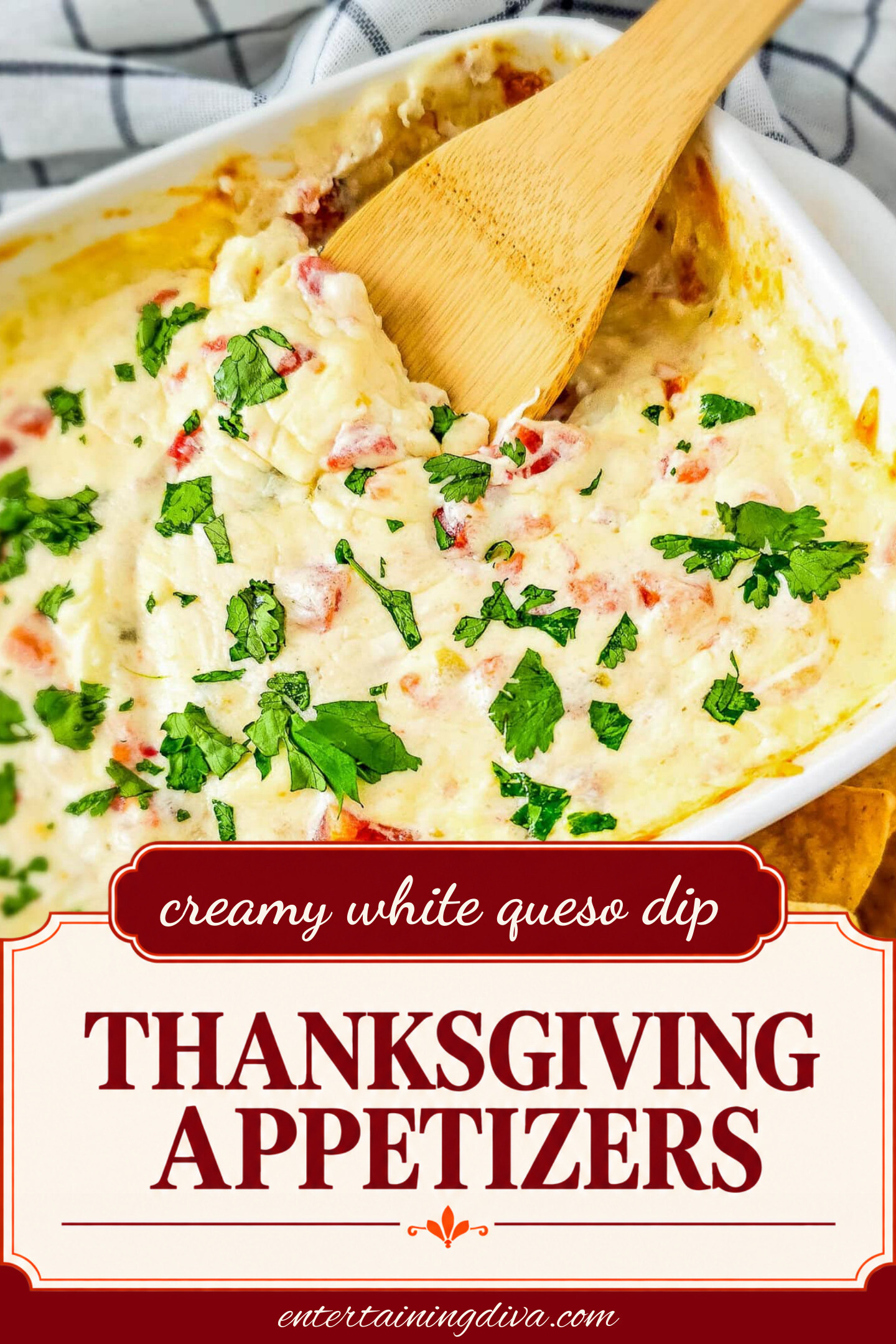 Close up of white queso dip in a baking dish with a wooden spoon